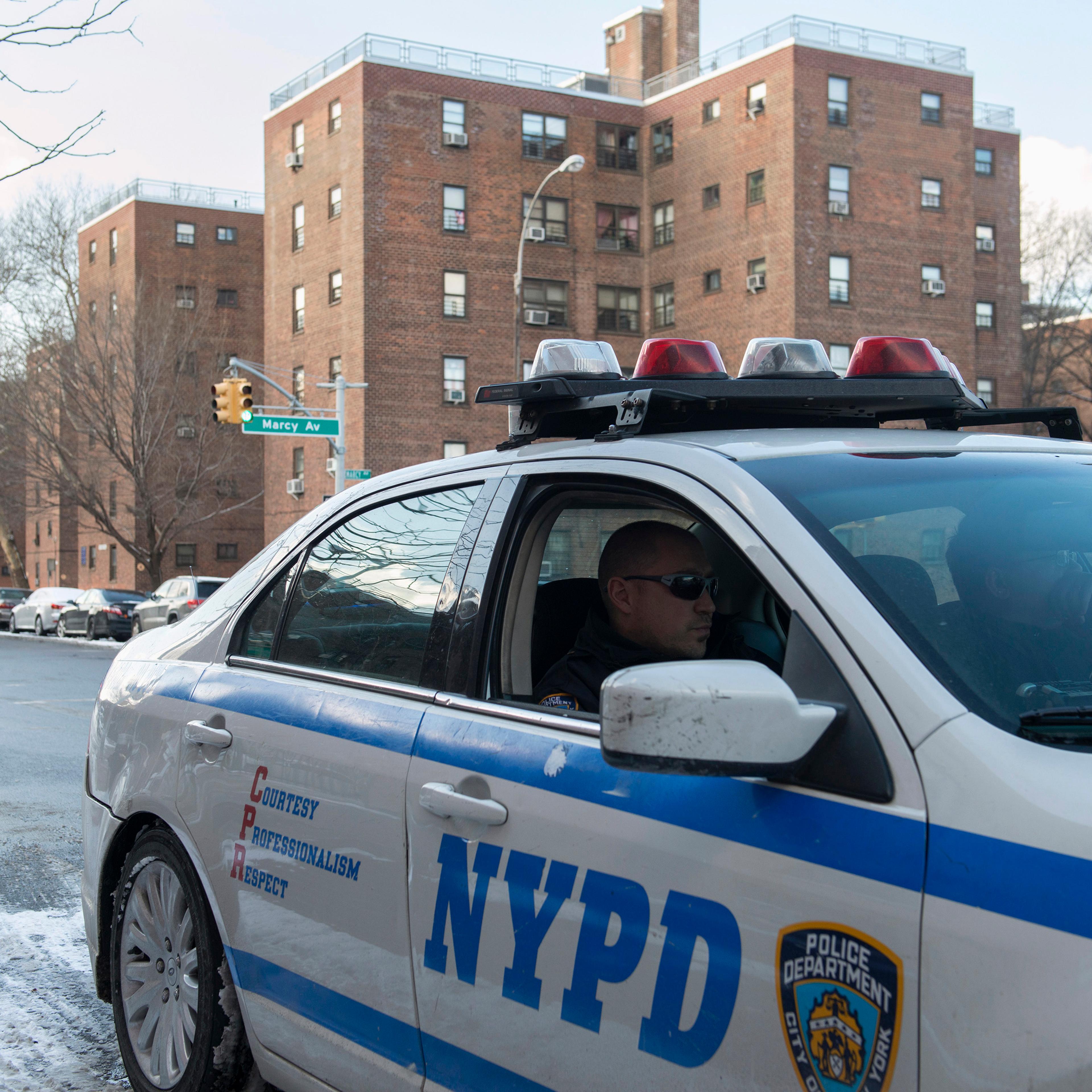 A NYPD patrol vehicle is seen near the Marcy Houses public housing development in the Brooklyn borough of New York