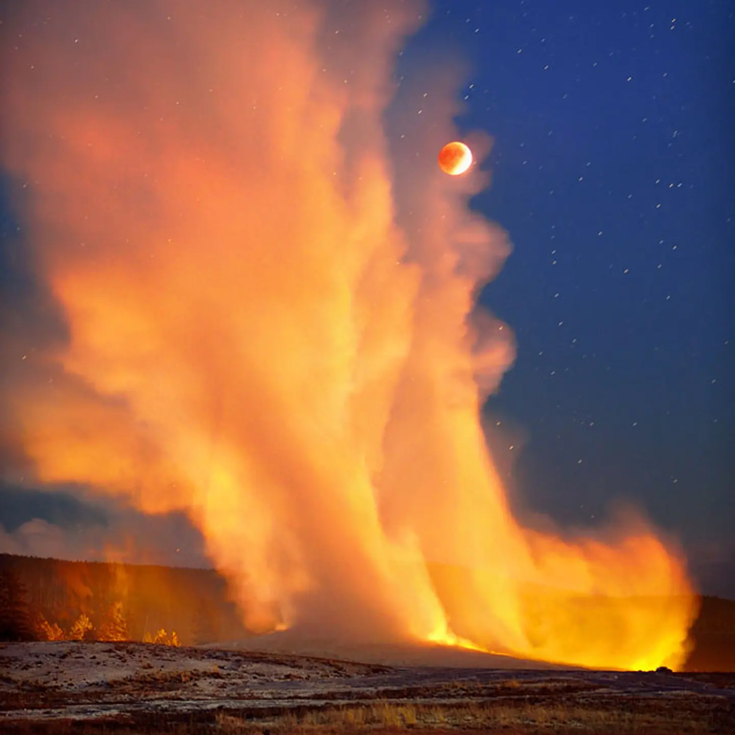 Old Faithful erupts during the super blood moon eclipse on Sept. 27, 2015 over Yellowstone National Park.