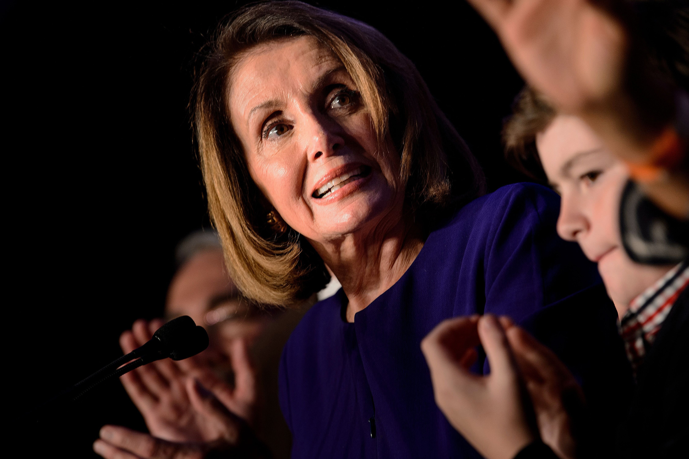 Surrounded by supporters House Minority Leader Nancy Pelosi celebrates a projected Democratic Party takeover of the House of Representatives during a midterm election night party hosted by the Democratic Congressional Campaign Committee in Washington, DC on on Nov. 6, 2018. 