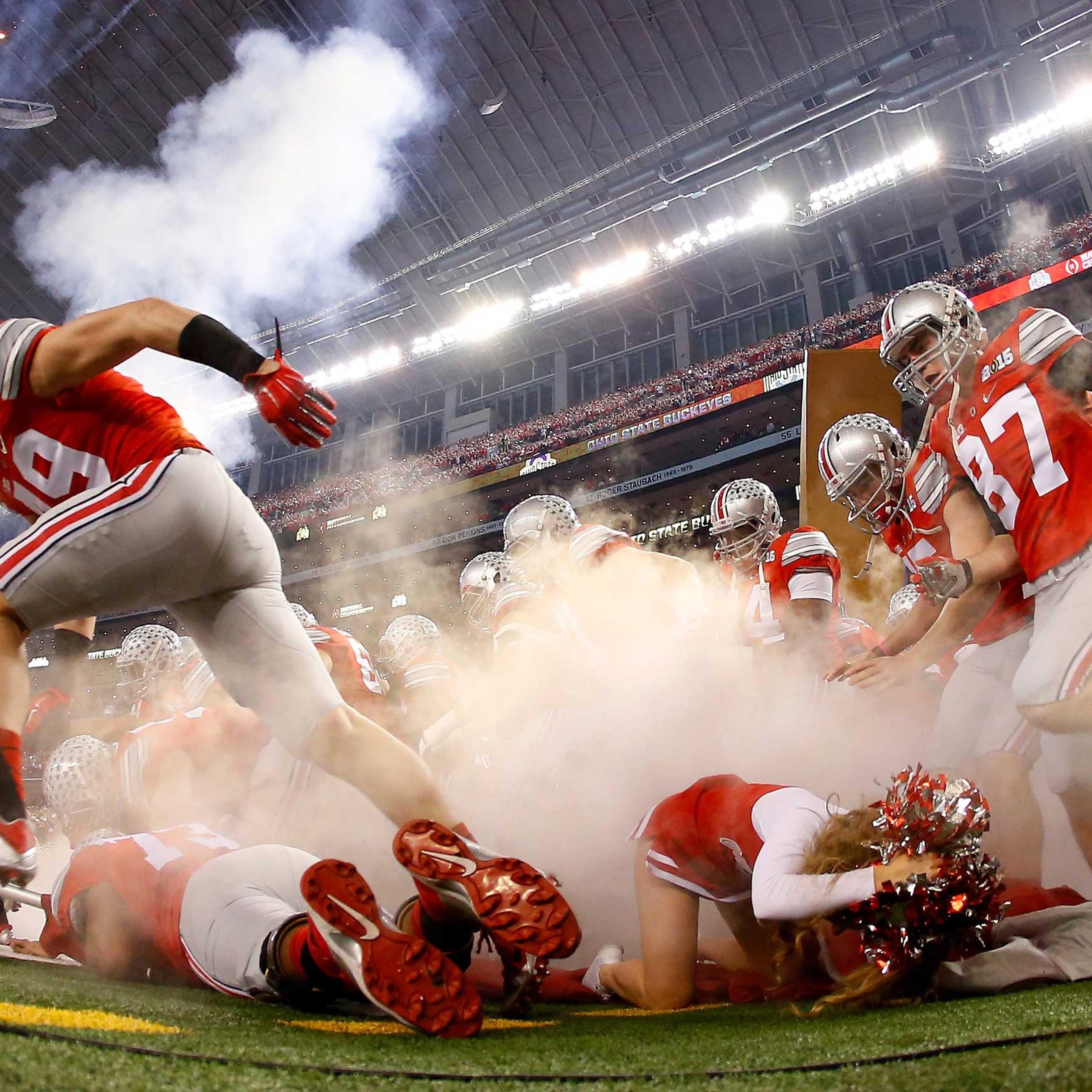 An Ohio State Buckeyes cheerleader falls as the Buckeyes run out to the field before the College Football Playoff National Championship Game at AT&T Stadium on Jan. 12, 2015 in Arlington, Texas.