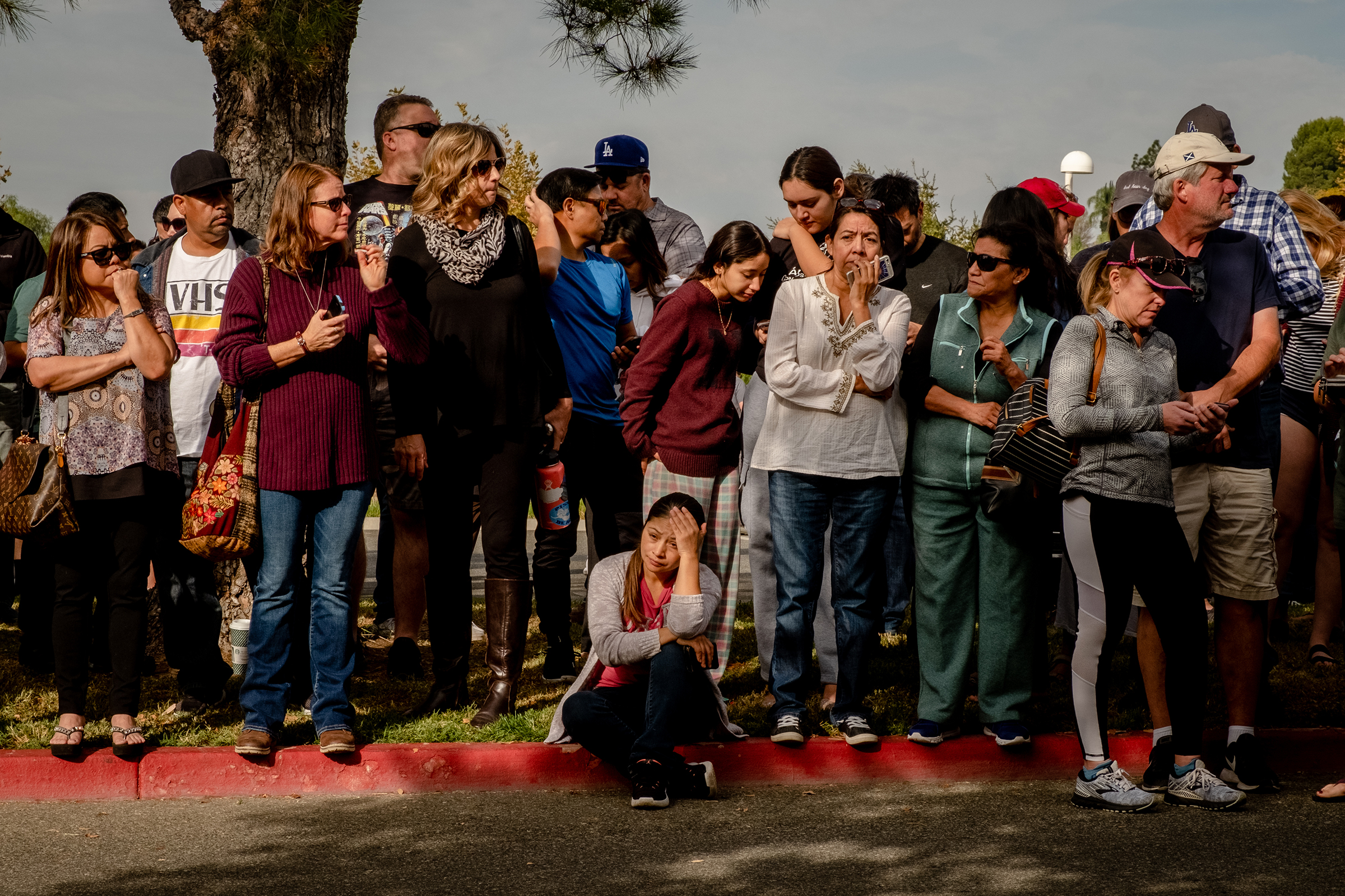 Parents wait for their children to arrive on buses to the reunification center in Santa Clarita, Calif., on Nov. 14.