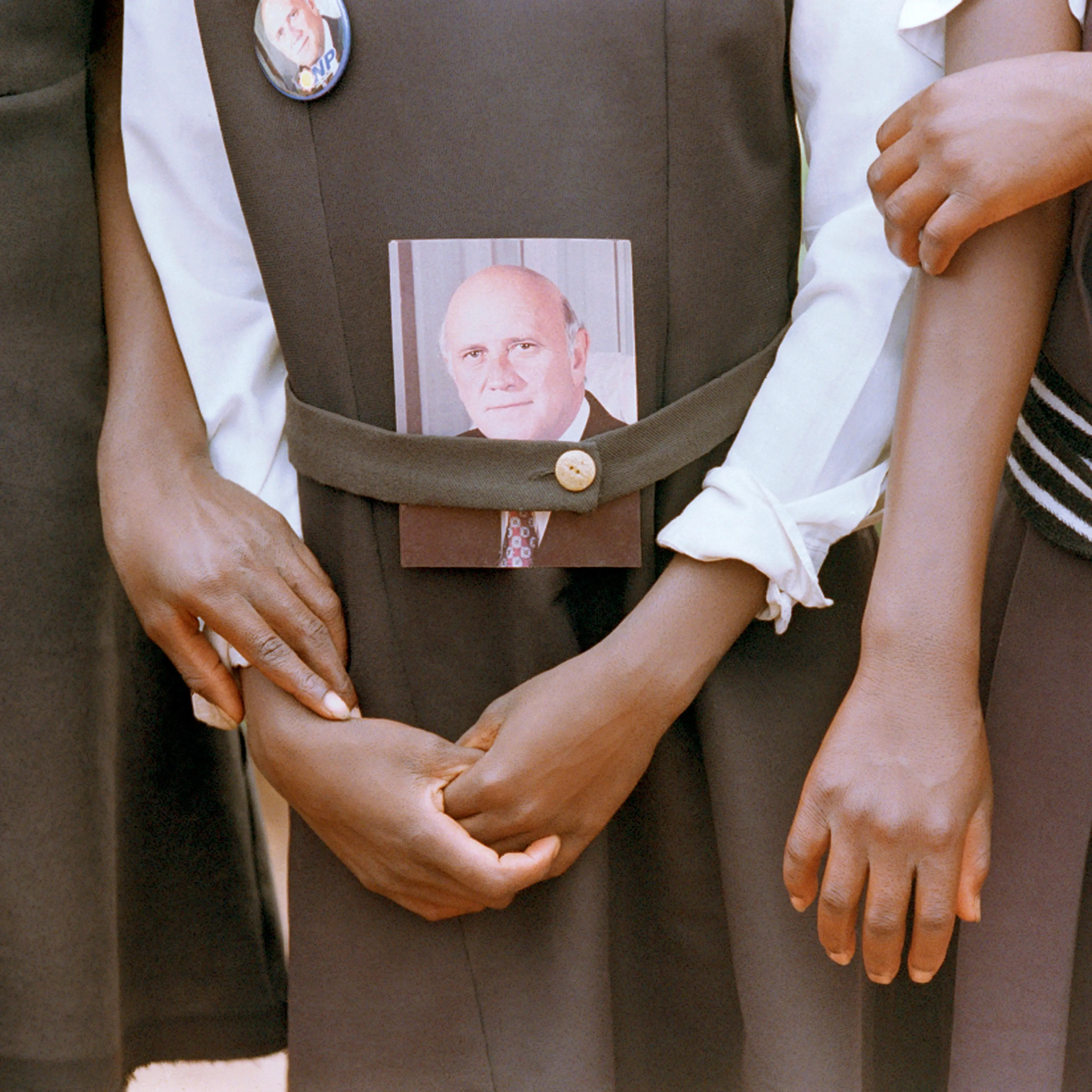 School children hold hands while awaiting the arrival of President F.W. de Klerk at a campaign rally in January 1994.
