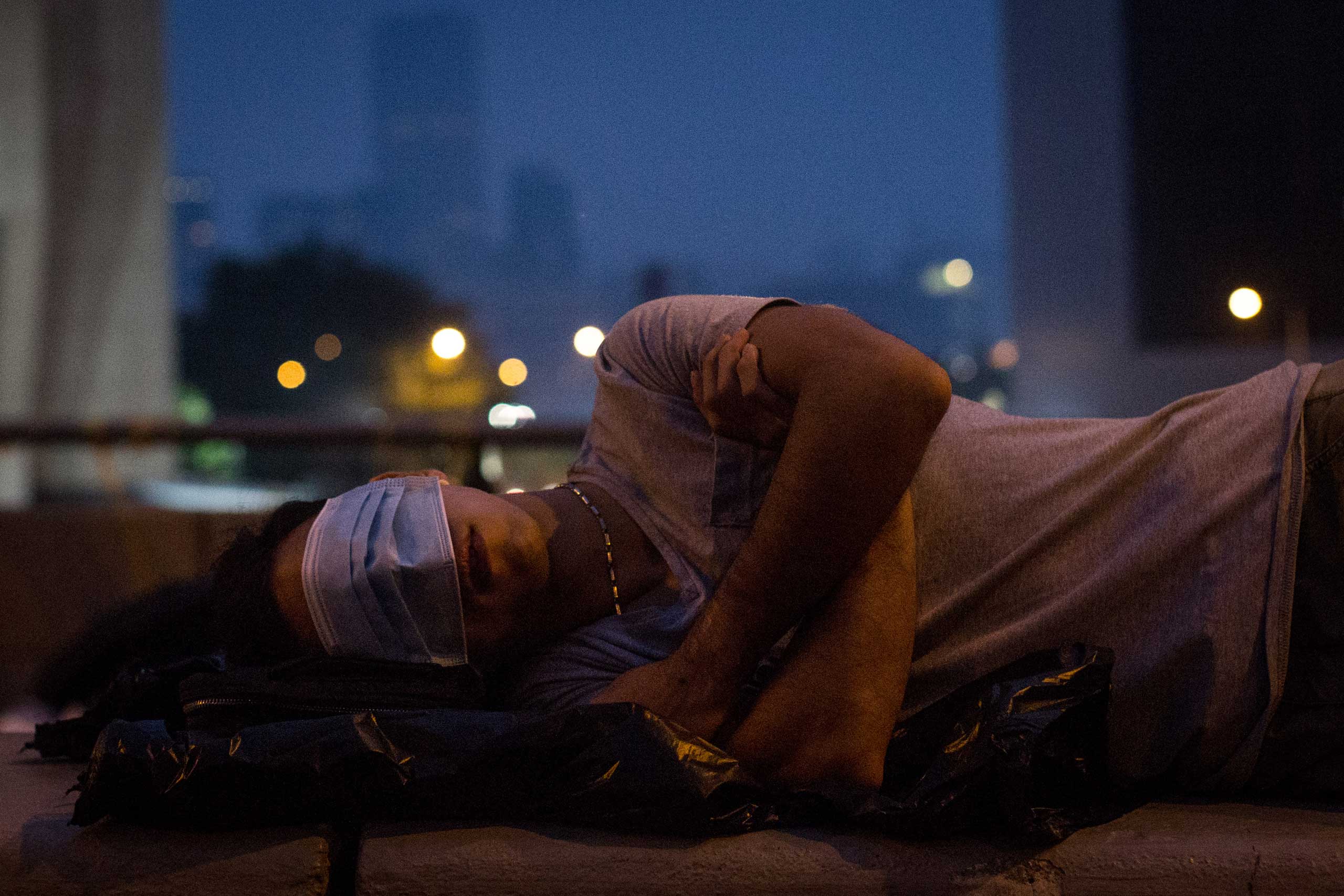 A pro-democracy protester sleeps on a concrete road divider on a street outside the Hong Kong Government Complex on Oct. 5, 2014 in Hong Kong.