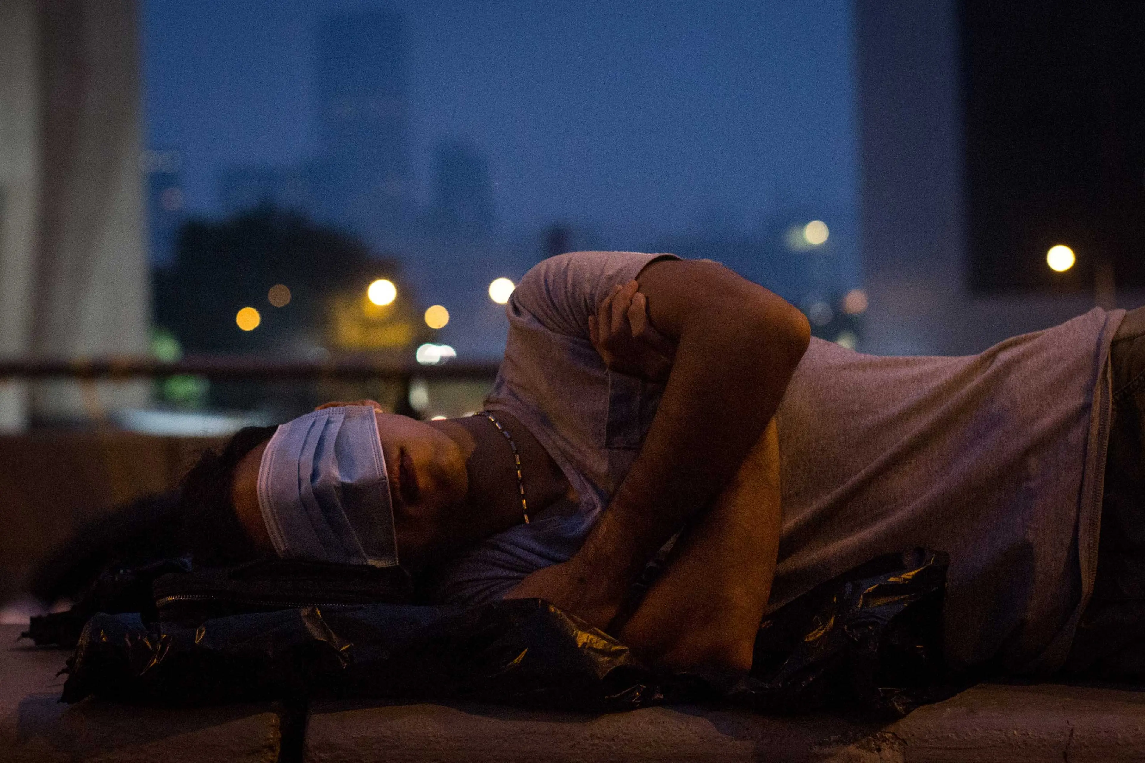 A pro-democracy protester sleeps on a concrete road divider on a street outside the Hong Kong Government Complex on Oct. 5, 2014 in Hong Kong.