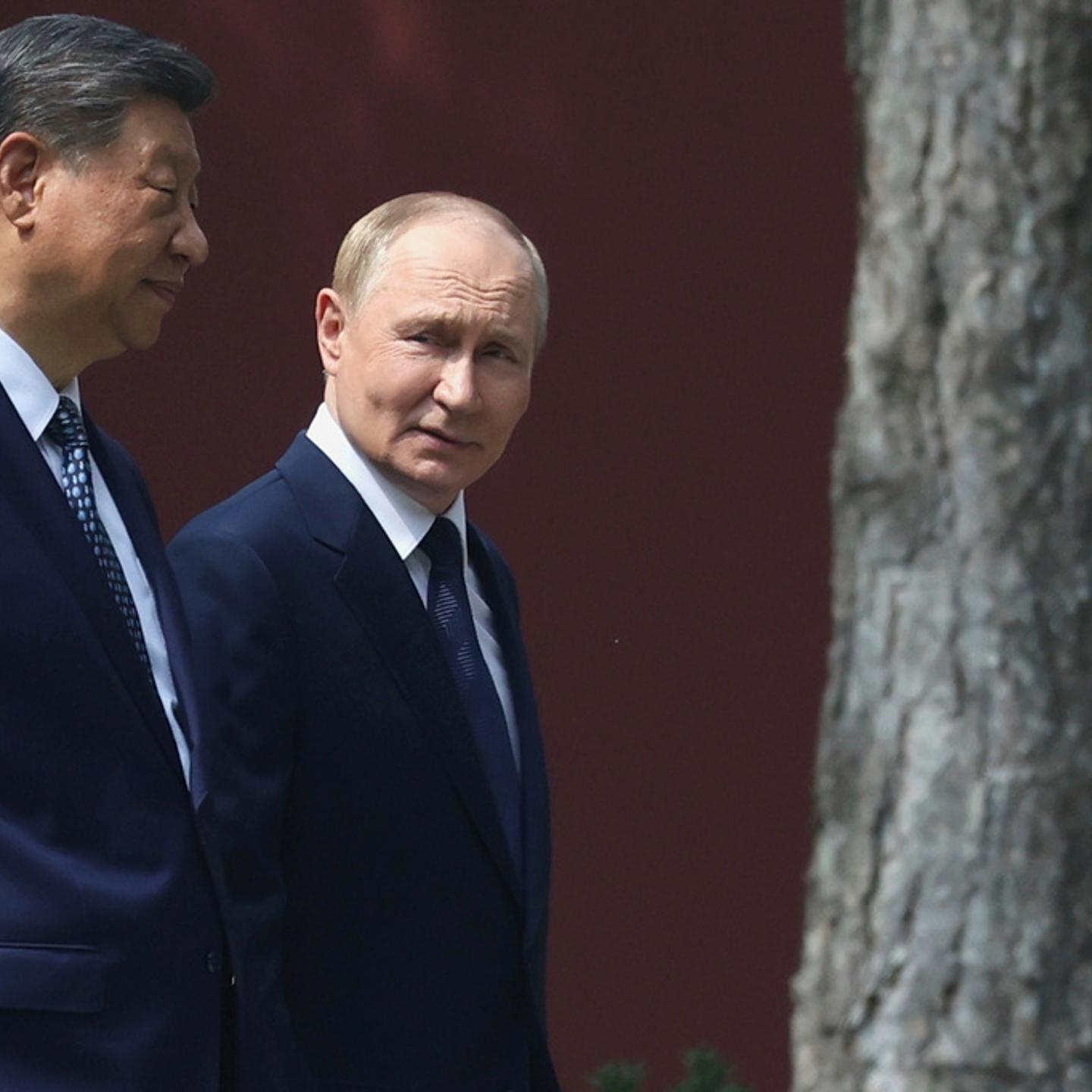 Russian President Vladimir Putin, right, speaks with Chinese President Xi Jinping during a walk at the Zhongnanhai leadership compound in Beijing, China, Sept. 2, 2025.