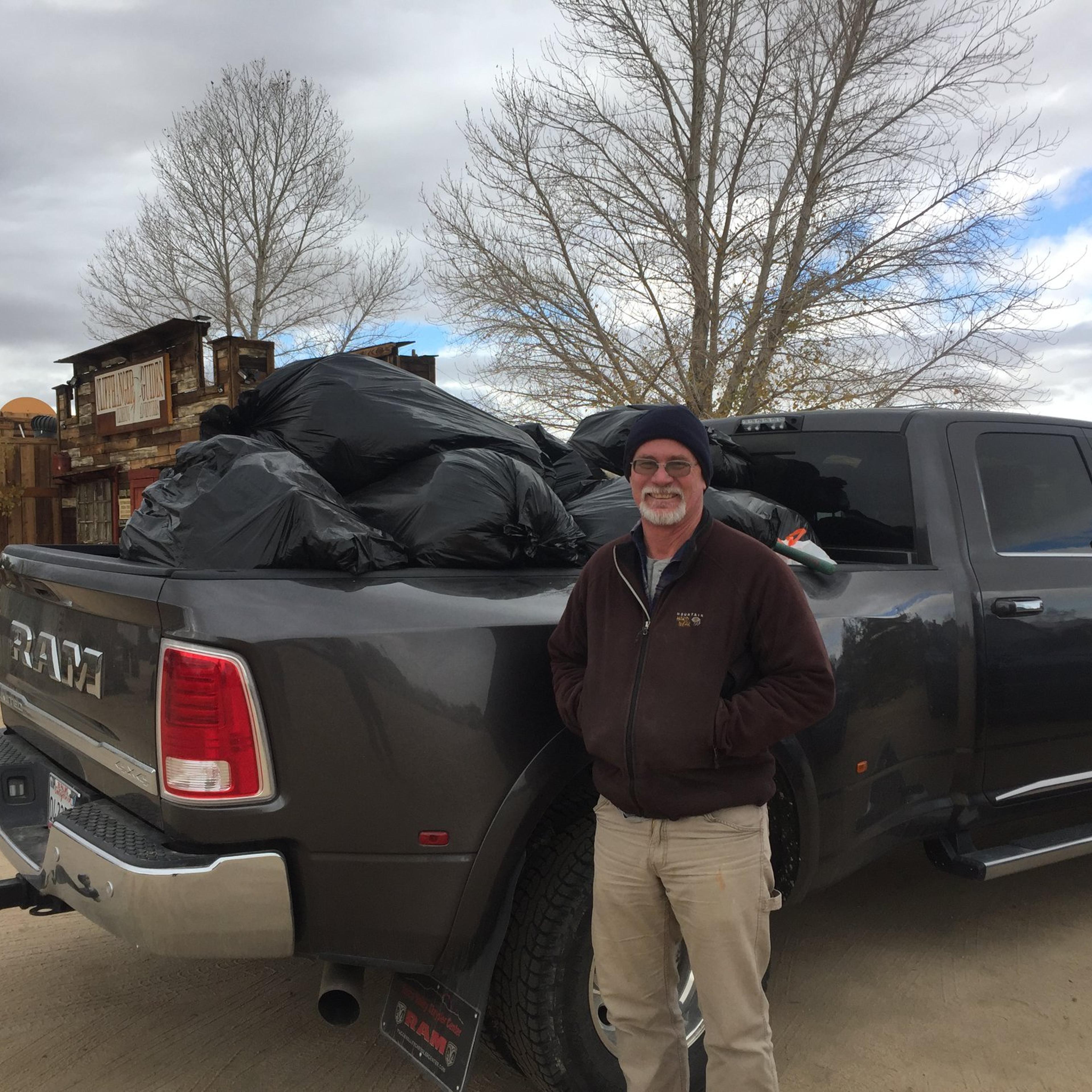 Seth Zaharias, co-owner of Cliffhanger Guides, helps haul trash out of Joshua Tree National Park on Jan. 1, 2019.