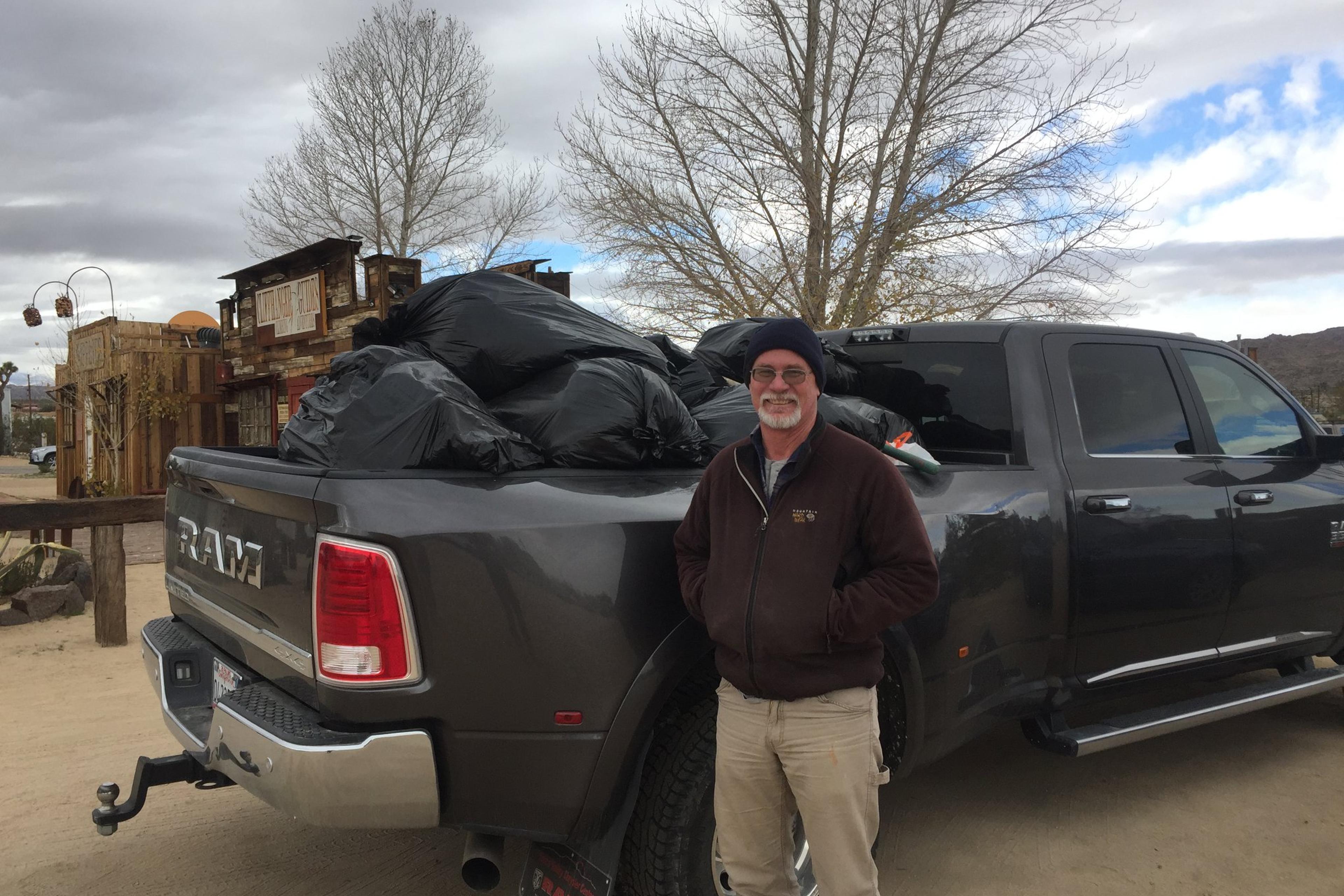 Seth Zaharias, co-owner of Cliffhanger Guides, helps haul trash out of Joshua Tree National Park on Jan. 1, 2019.