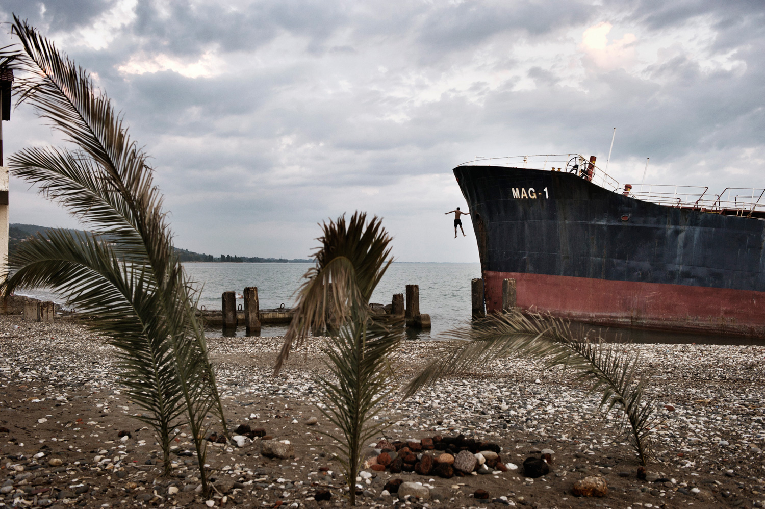 An Abkhaz boy jumps from an abandoned Turkish freighter beached near central Sukhumi, Abkhazia. After more than 15 years of economic blockades by Georgia, investment in Abkhazia is almost nonexistent–the resorts are empty, and the economy is stagnant. 
