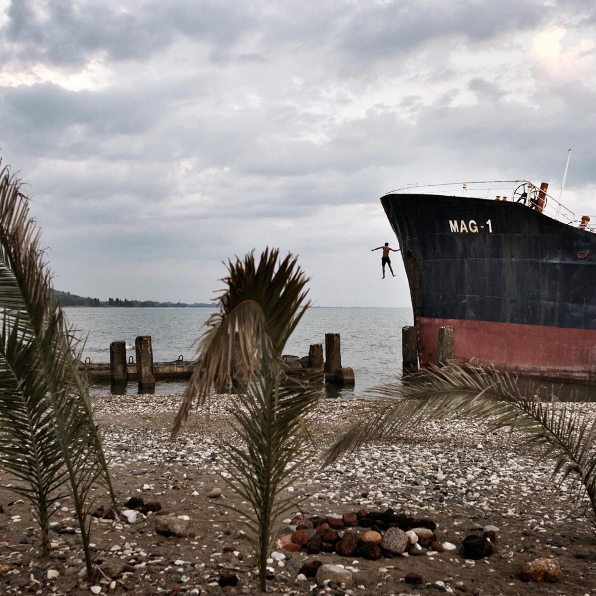 An Abkhaz boy jumps from an abandoned Turkish freighter beached near central Sukhumi, Abkhazia. After more than 15 years of economic blockades by Georgia, investment in Abkhazia is almost nonexistent–the resorts are empty, and the economy is stagnant.