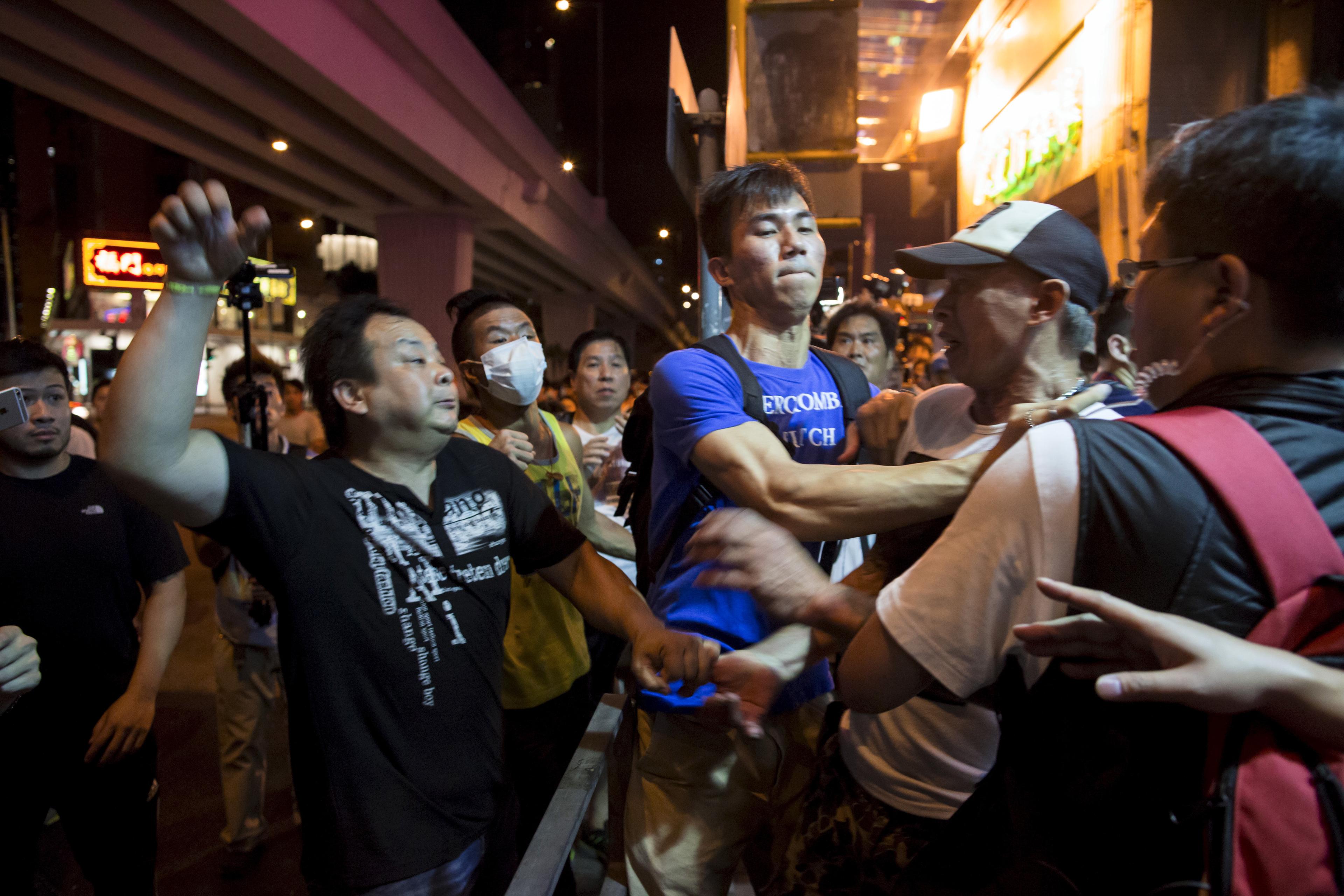 Localist protester scuffles with a pro-China demonstrator during an anti-China protest at Mongkok shopping district in Hong Kong, China