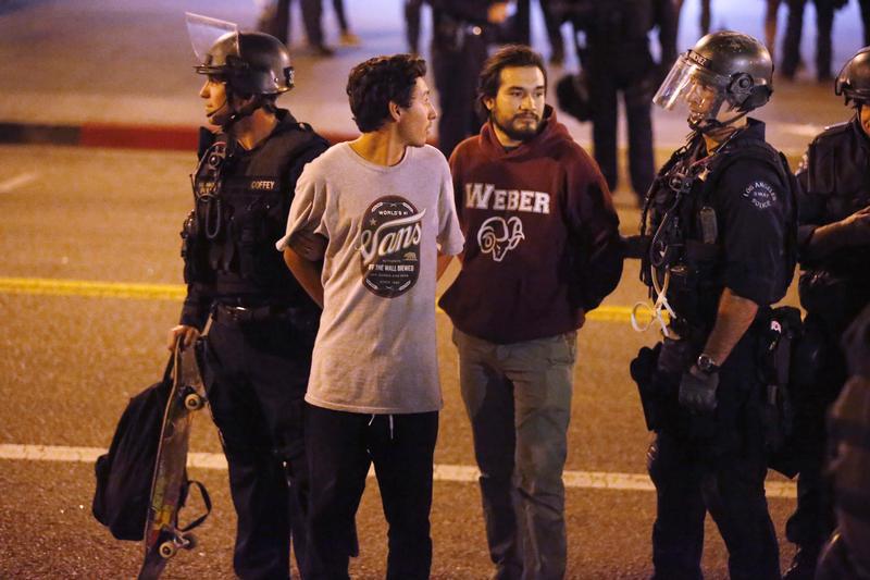 Police detain protesters during a march in Los Angeles, California
