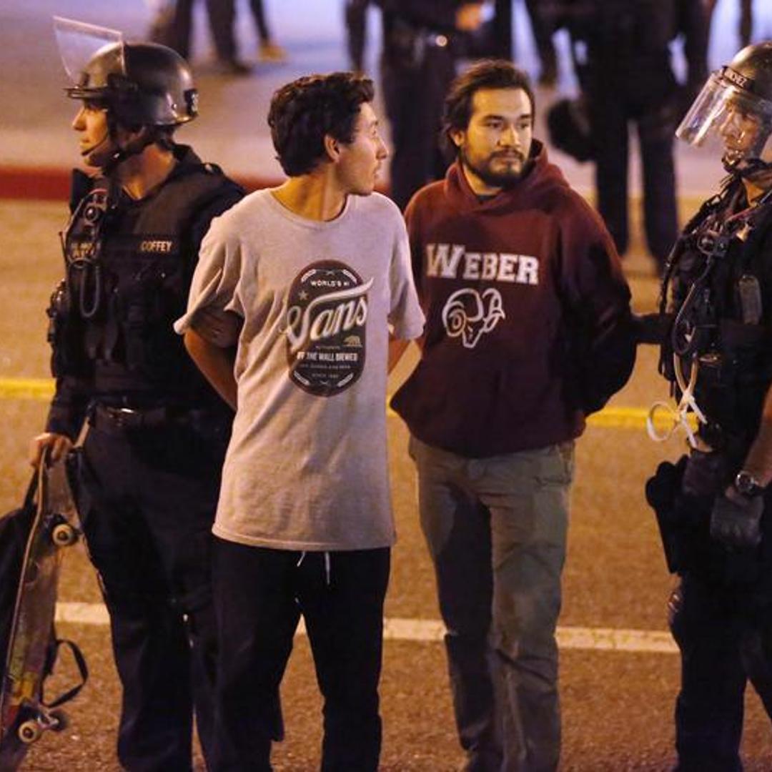 Police detain protesters during a march in Los Angeles, California