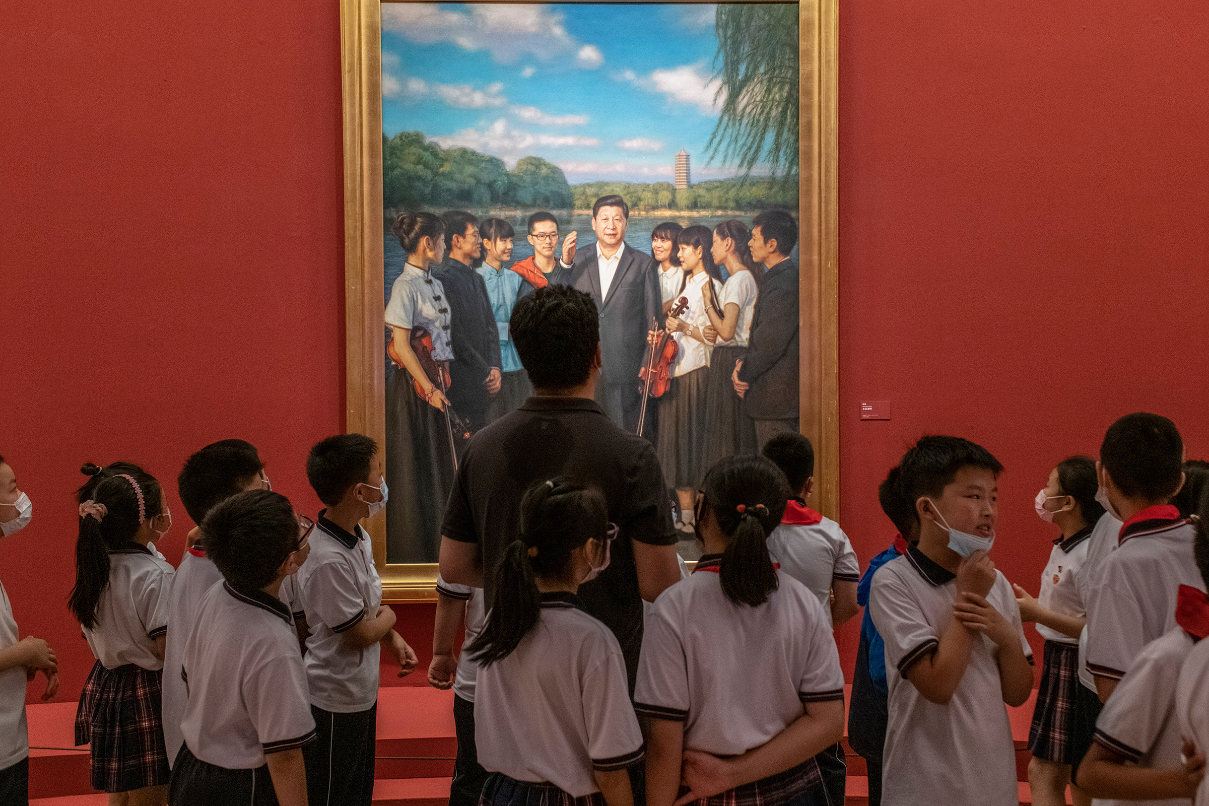 Visitors in front of a portrait of Xi at the National Art Museum in Beijing on June 30, 2021.