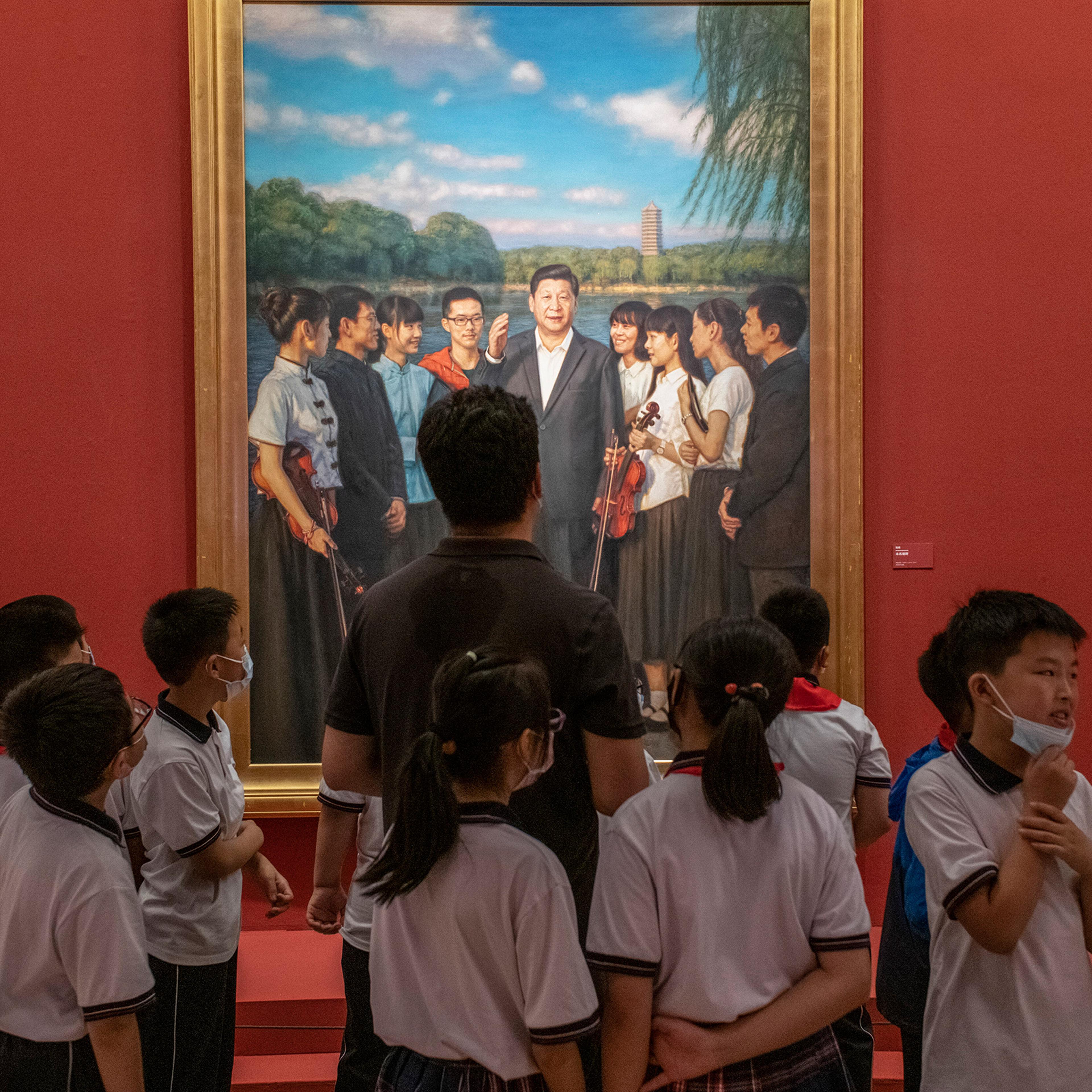 Visitors in front of a portrait of Xi at the National Art Museum in Beijing on June 30, 2021.