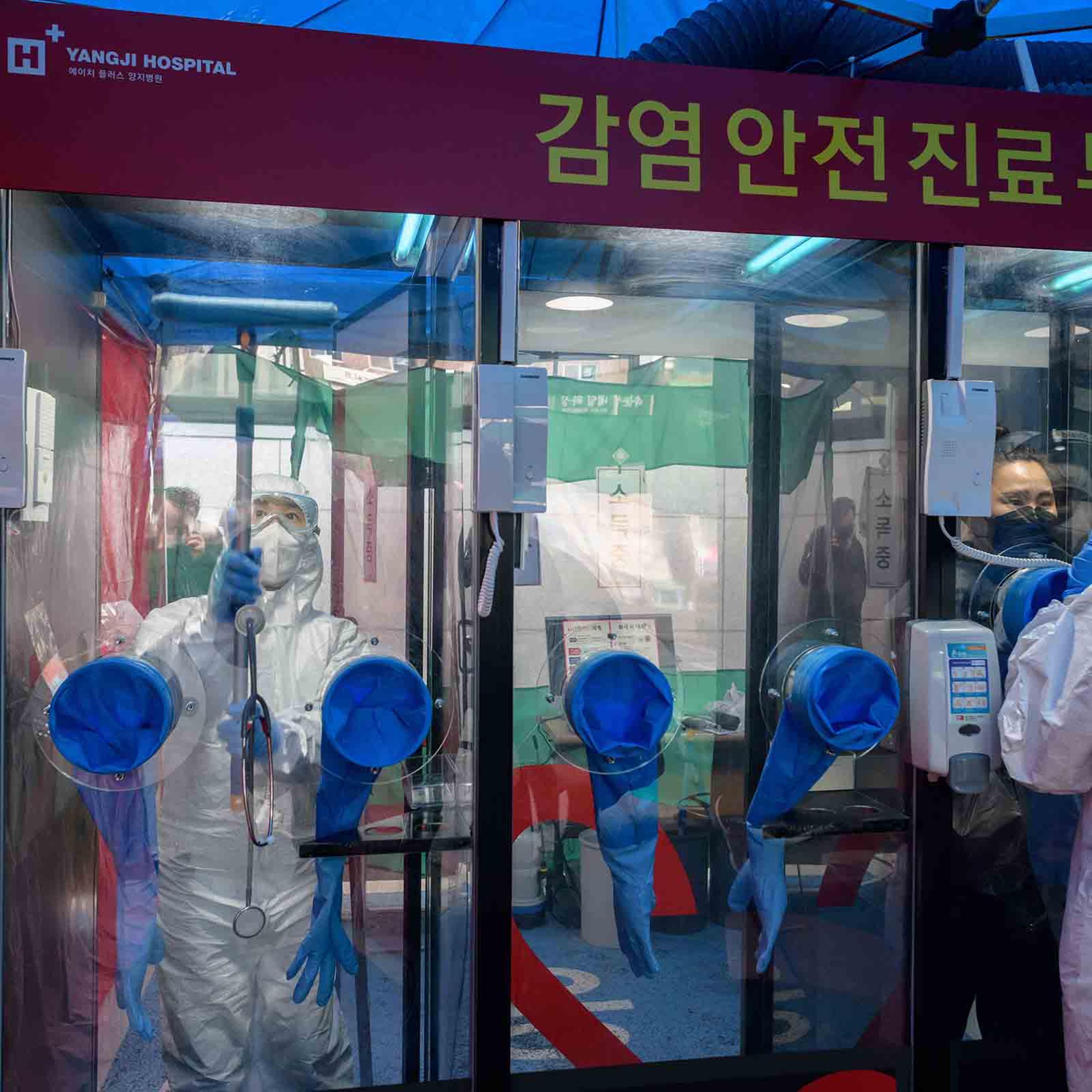 A woman consults a nurse at a walk-up COVID-19 testing booth outside Yangji Hospital in Seoul