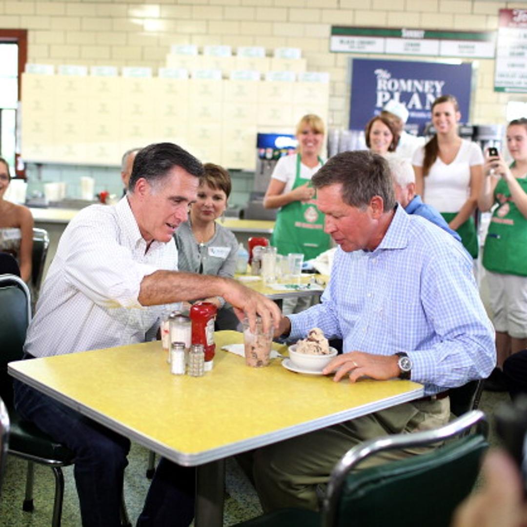 Republican presidential candidate and former Massachusetts Governor Mitt Romney (L) eats ice cream with Ohio Governor John Kasich during a campaign rally at Tom's Ice Cream Bowl on August 14, 2012 in Zanesville, Ohio.