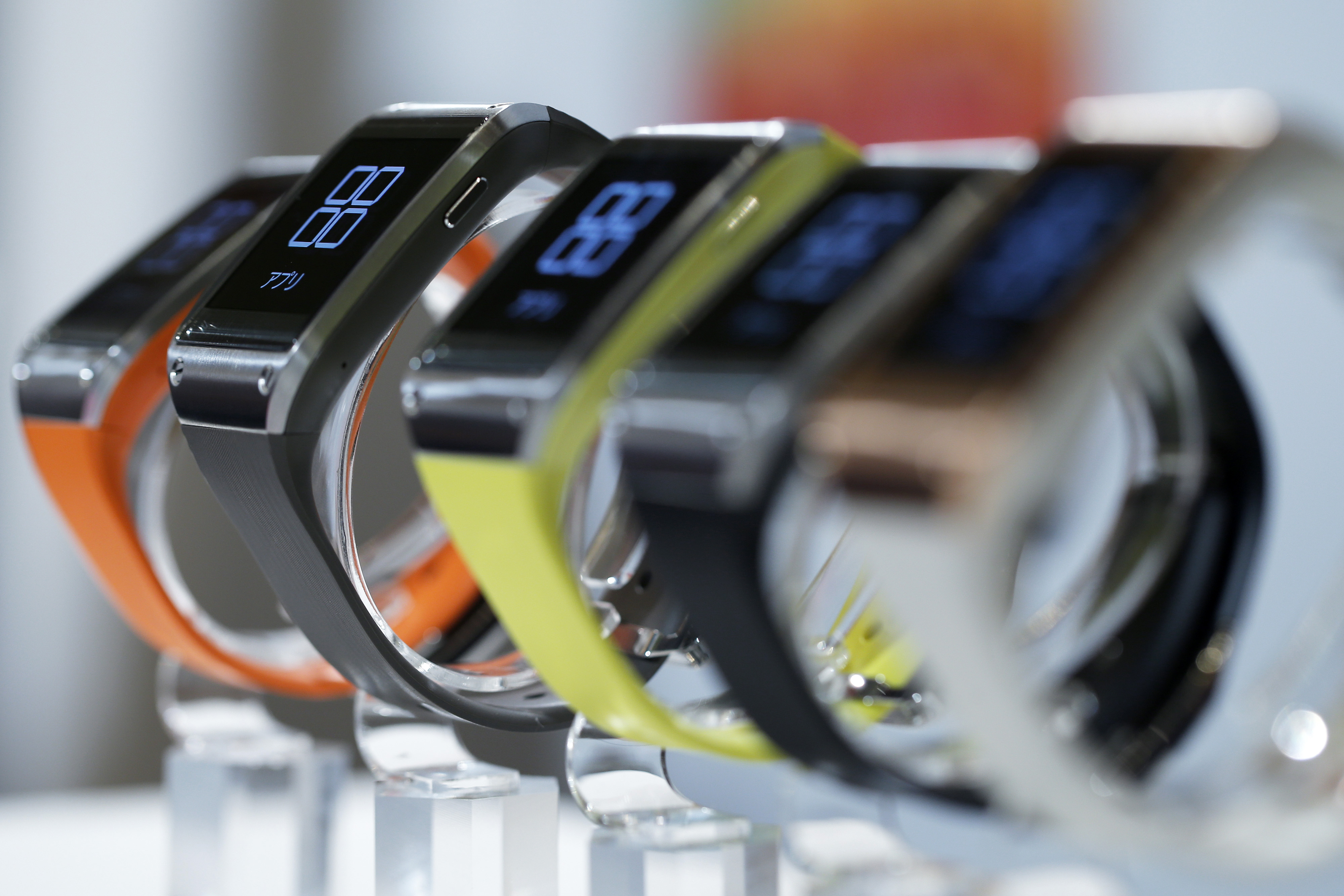 Samsung Electronics Co.'s Galaxy Gear wearable devices for KDDI Corp.'s "au" brand sit on display during a product launch event in Tokyo on Oct. 2, 2013.