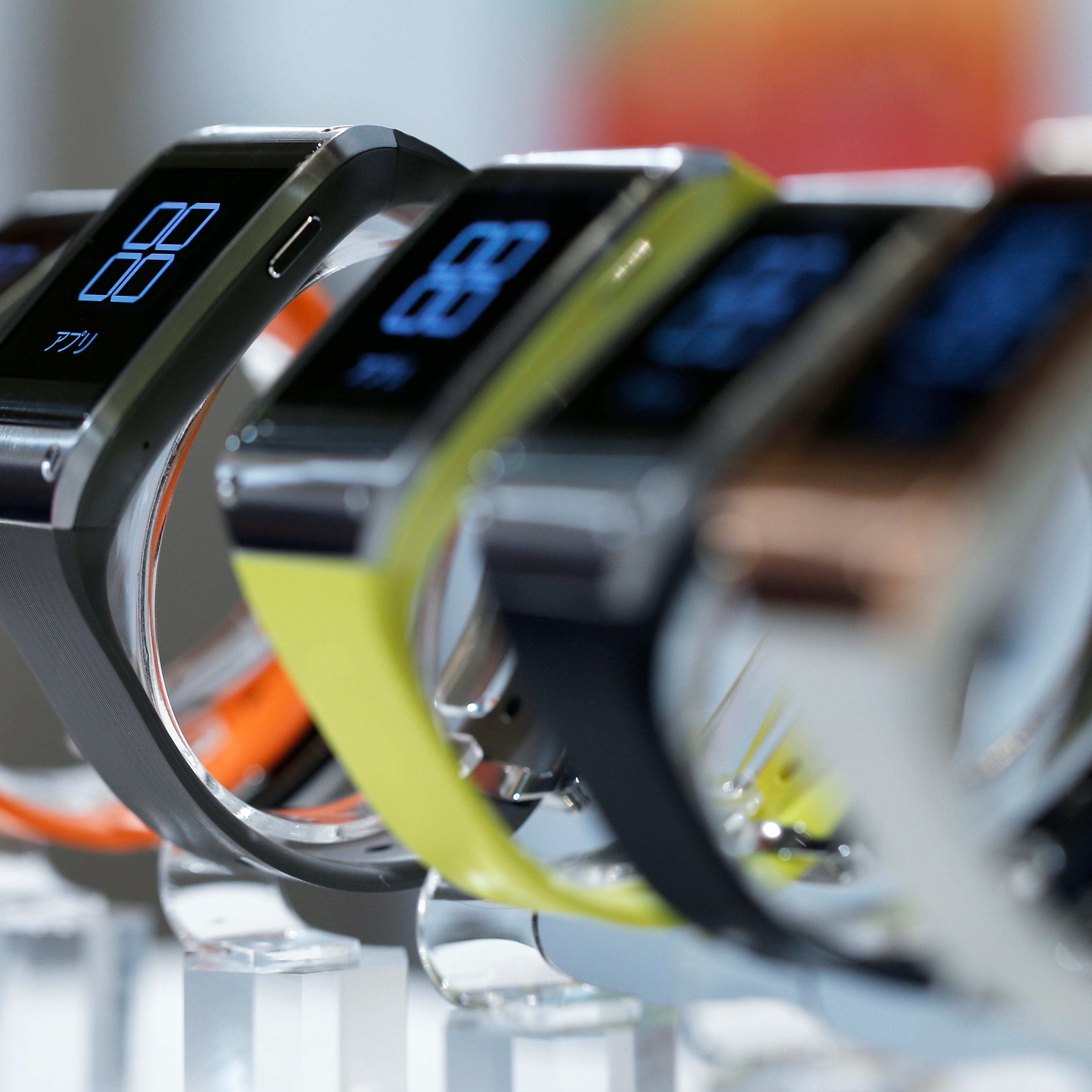 Samsung Electronics Co.'s Galaxy Gear wearable devices for KDDI Corp.'s "au" brand sit on display during a product launch event in Tokyo on Oct. 2, 2013.