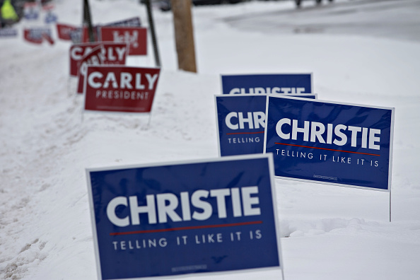Campaign signs supporting Chris Christie, governor of New Jersey and 2016 Republican presidential candidate, and Carly Fiorina, former chairman and chief executive officer of Hewlett-Packard Co. and 2016 Republican presidential candidate, stand along a r