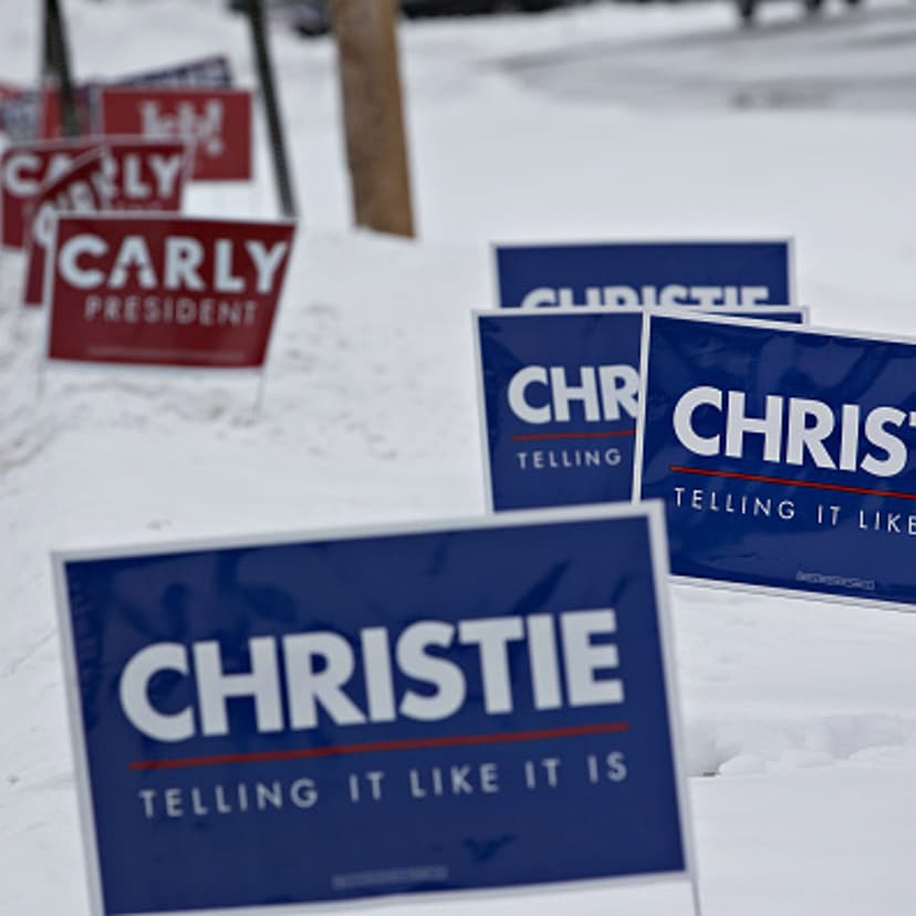 Campaign signs supporting Chris Christie, governor of New Jersey and 2016 Republican presidential candidate, and Carly Fiorina, former chairman and chief executive officer of Hewlett-Packard Co. and 2016 Republican presidential candidate, stand along a r