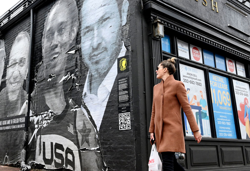 People walk past a mural created by artist Isaac Campbell in Georgetown that features US women's basketball star Brittney Griner and other Americans detained abroad as part of the Bring Our Families Home Campaign in Washington, DC.
