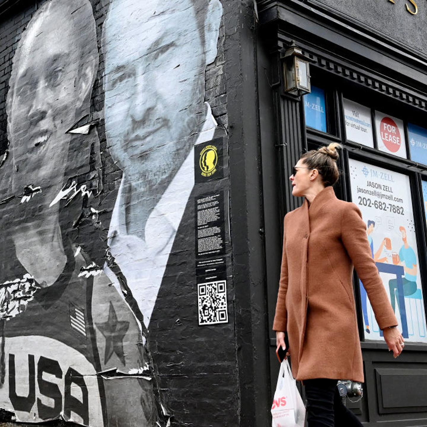 People walk past a mural created by artist Isaac Campbell in Georgetown that features US women's basketball star Brittney Griner and other Americans detained abroad as part of the Bring Our Families Home Campaign in Washington, DC.