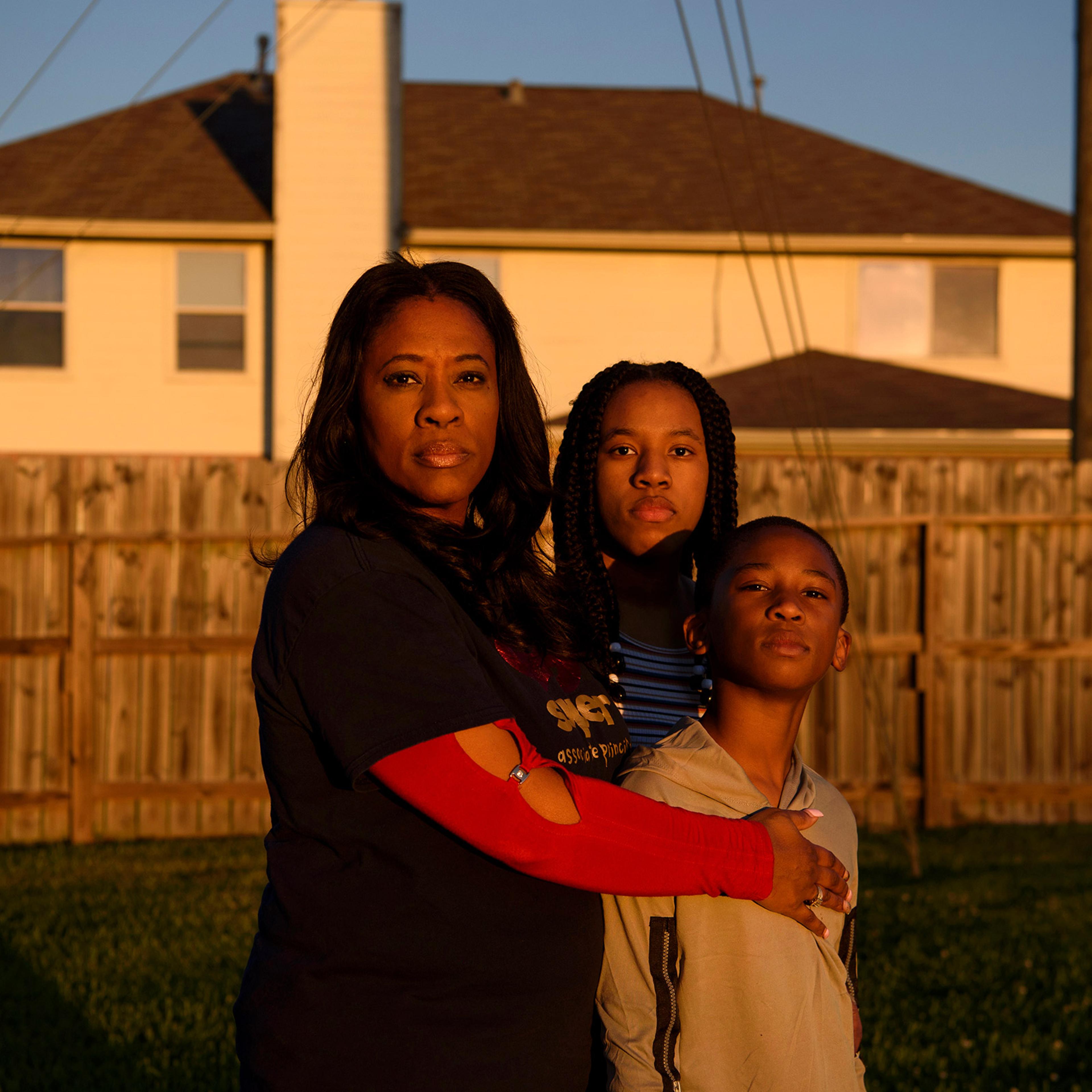 FRESNO, TX – OCTOBER 29, 2021: Adin James, 8, poses for a portrait alongside his mother, Ebony, 50, and his sister, Madison, 16, following the death of his father, Terrence James, who died after becoming ill with COVID-19, in Fresno, Texas.