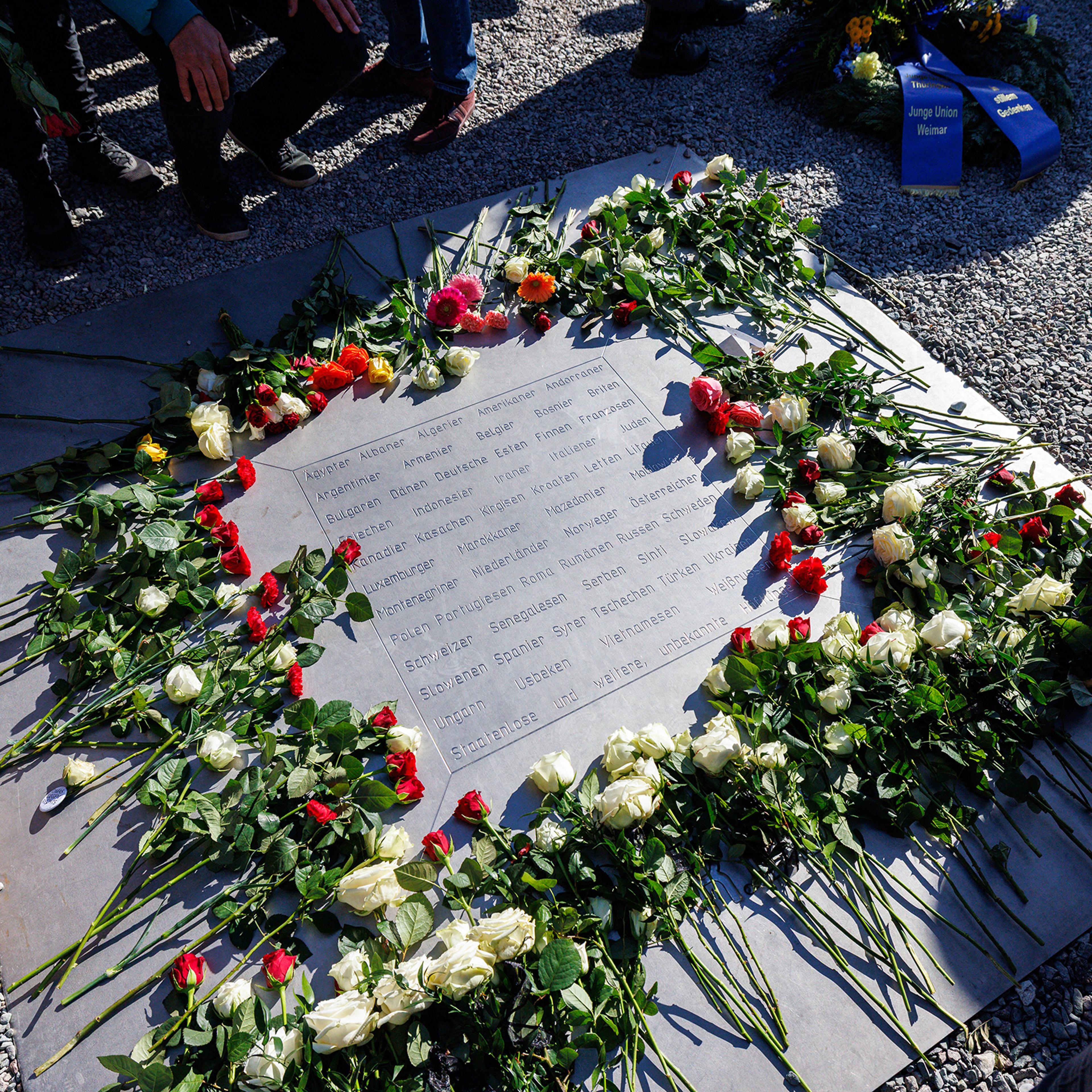 Flowers are left during the commemoration to mark the 80th anniversary of the liberation of the Buchenwald Nazi concentration camp at the camp's memorial site in Buchenwald, near Weimar, eastern Germany, on April 6, 2025.