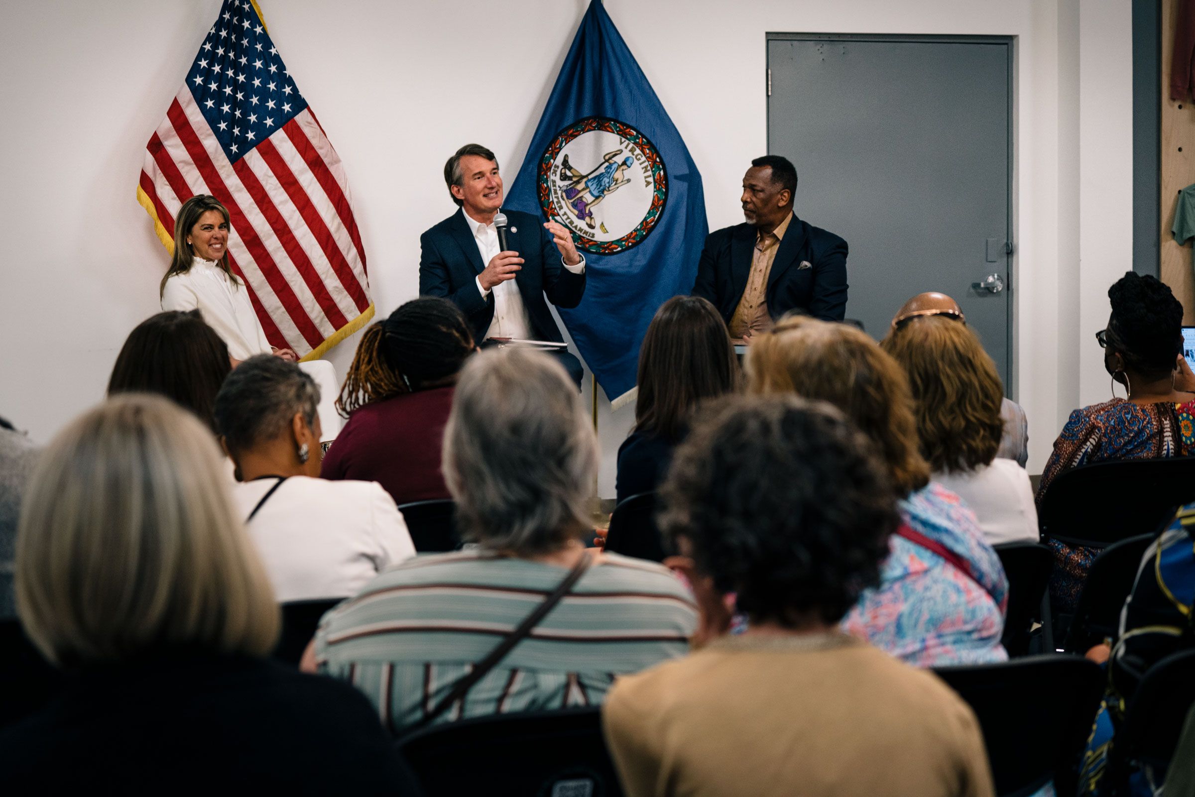 Gov. Glenn Youngkin speaks to constituents with his wife, Suzanne, and Pastor Calvin Duncan, right, at UTurn community center