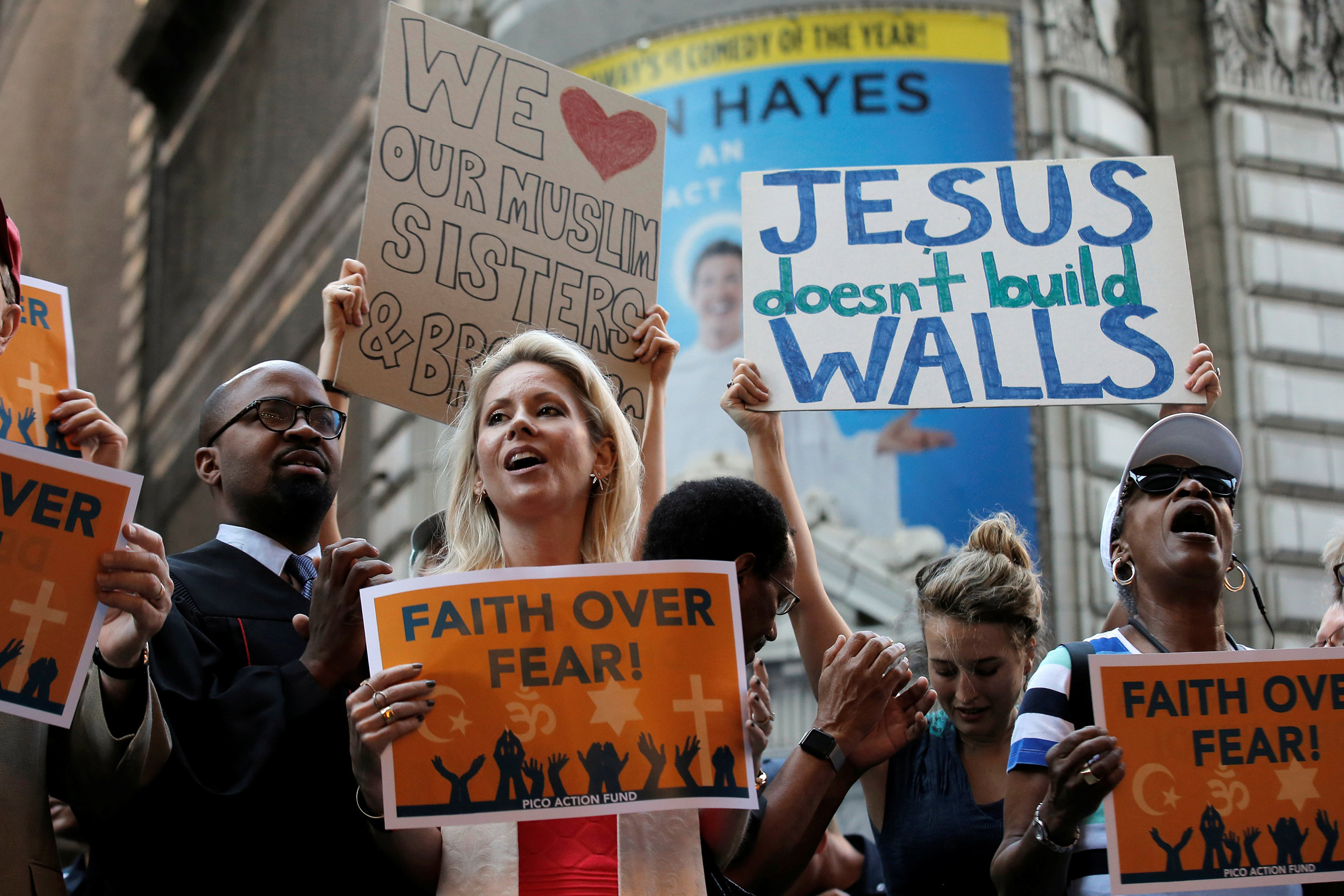 A group of interfaith religious leaders protest against Donald Trump outside a hotel where he was to meet with evangelical leaders in New York City, June 21, 2016.