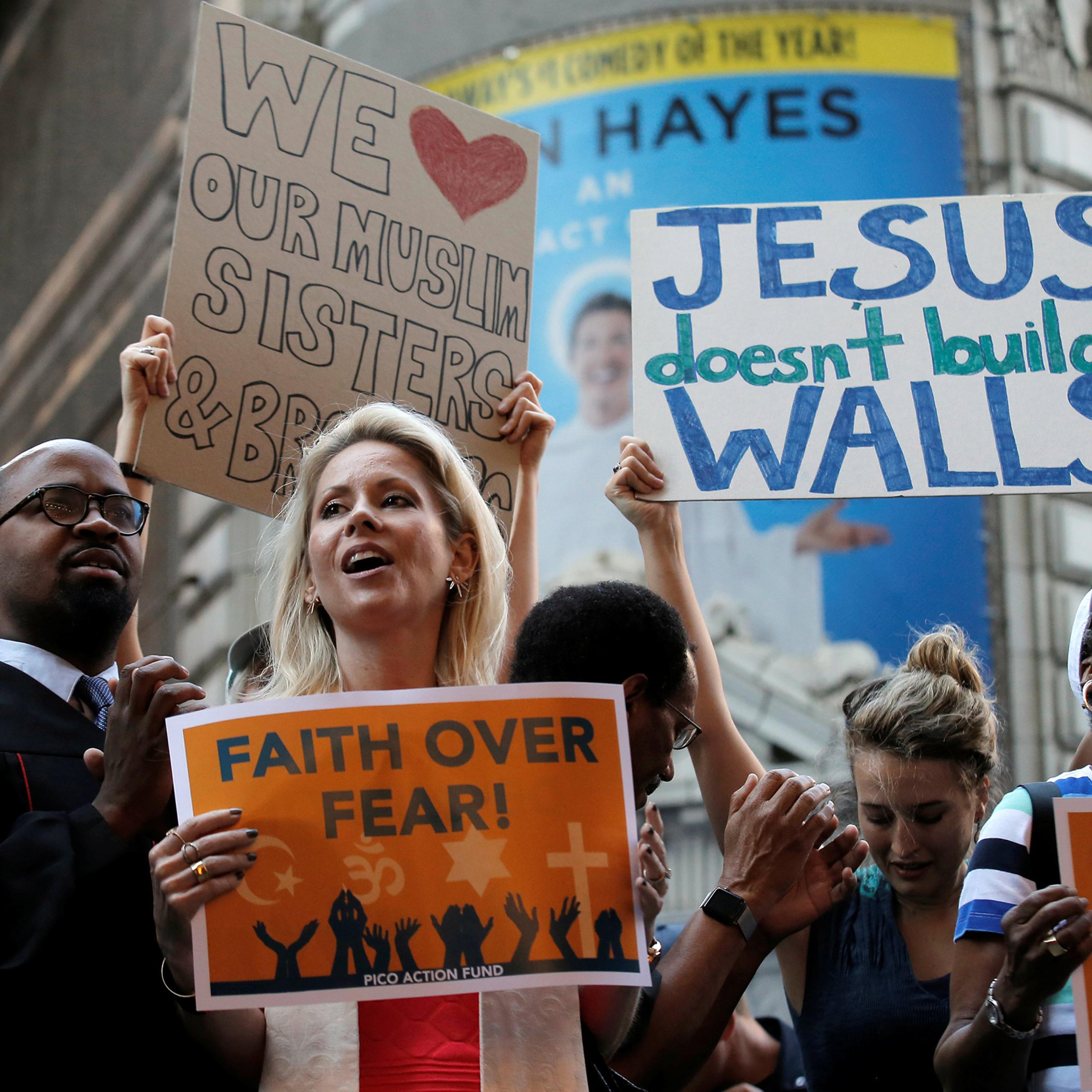 A group of interfaith religious leaders protest against Donald Trump outside a hotel where he was to meet with evangelical leaders in New York City, June 21, 2016.