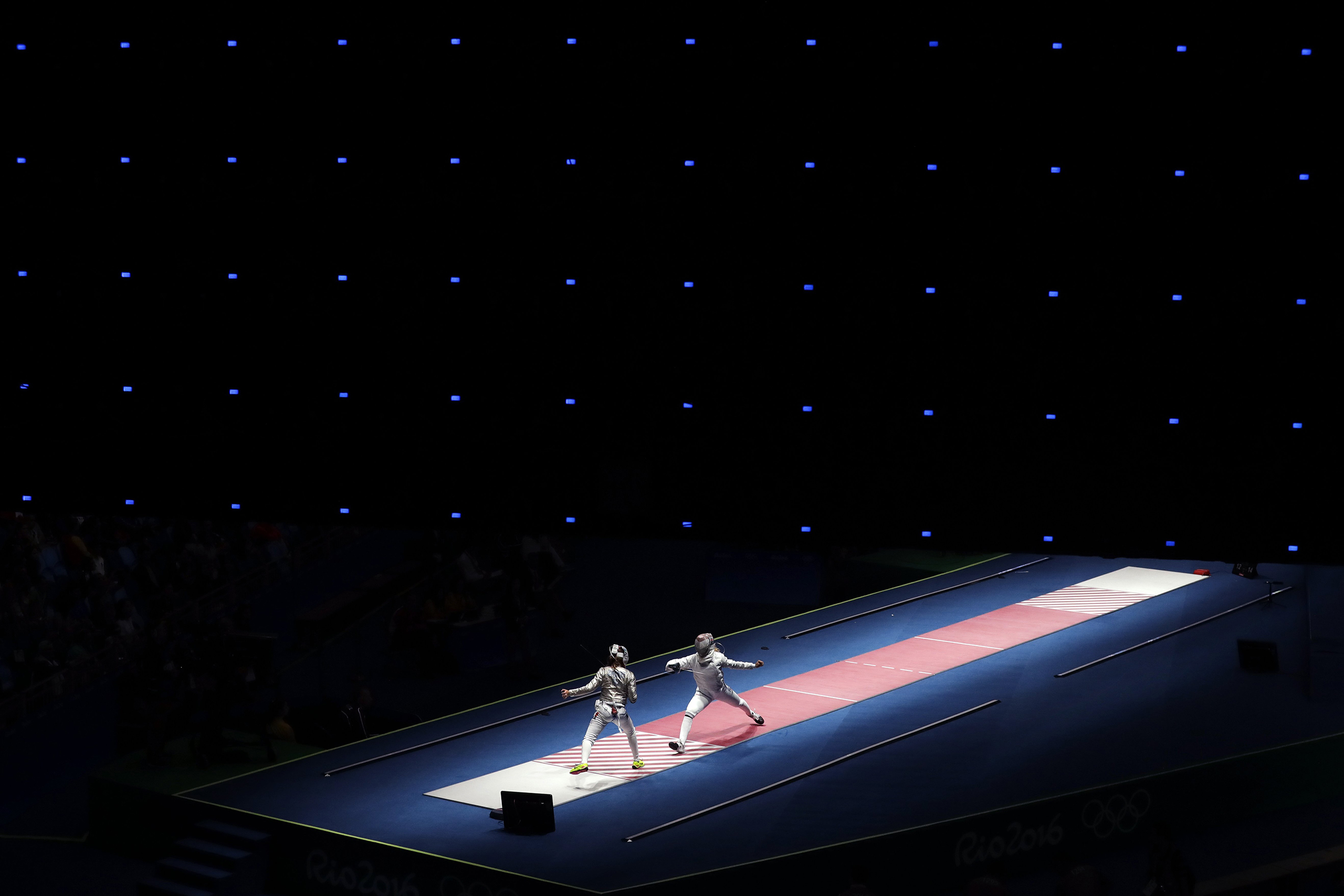 Anna Marton of Hungary, right, fences against Manon Brunet of France during women's saber individual fencing competition in the 2016 Summer Olympics in Rio de Janeiro, Brazil, Aug. 8, 2016.