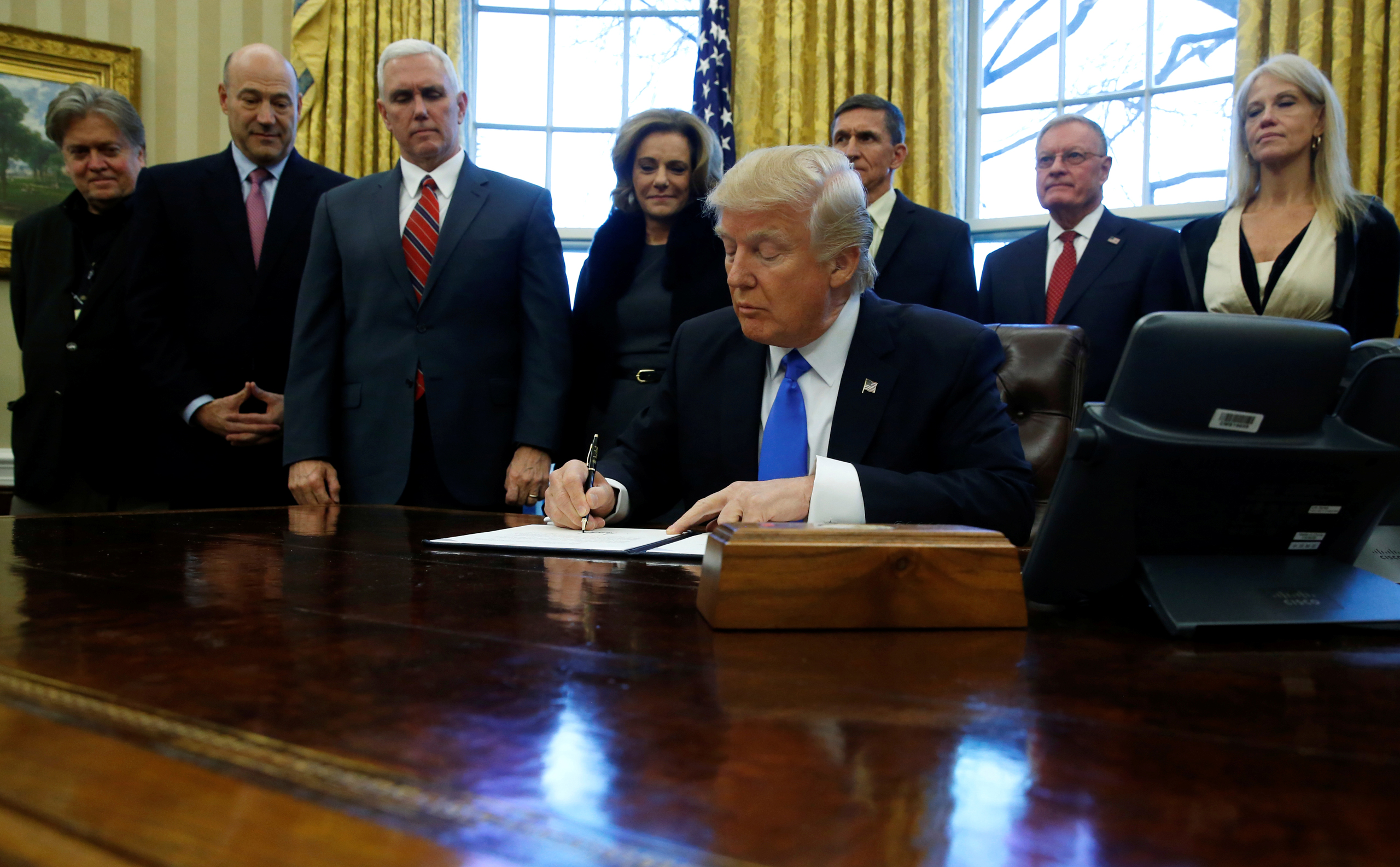 Trump signs a memorandum to security services directing them to defeat the Islamic State in the Oval Office at the White House in Washington