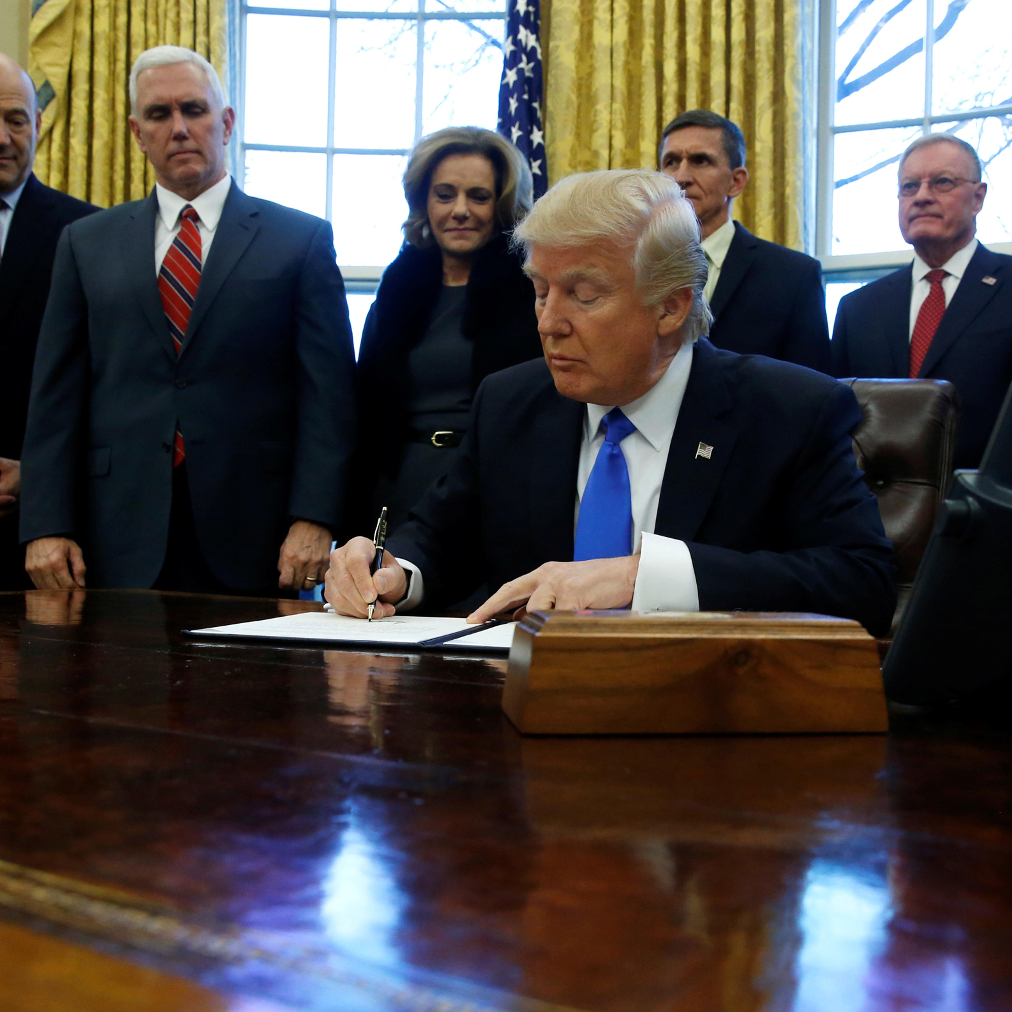 Trump signs a memorandum to security services directing them to defeat the Islamic State in the Oval Office at the White House in Washington