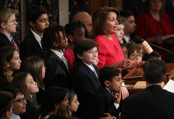 Surrounded by grandchildren and children of members of the House of Representatives, Speaker of the House Nancy Pelosi (D-CA) wields her gavel following her election as the next Speaker of the House during the first session of the 116th Congress at the U