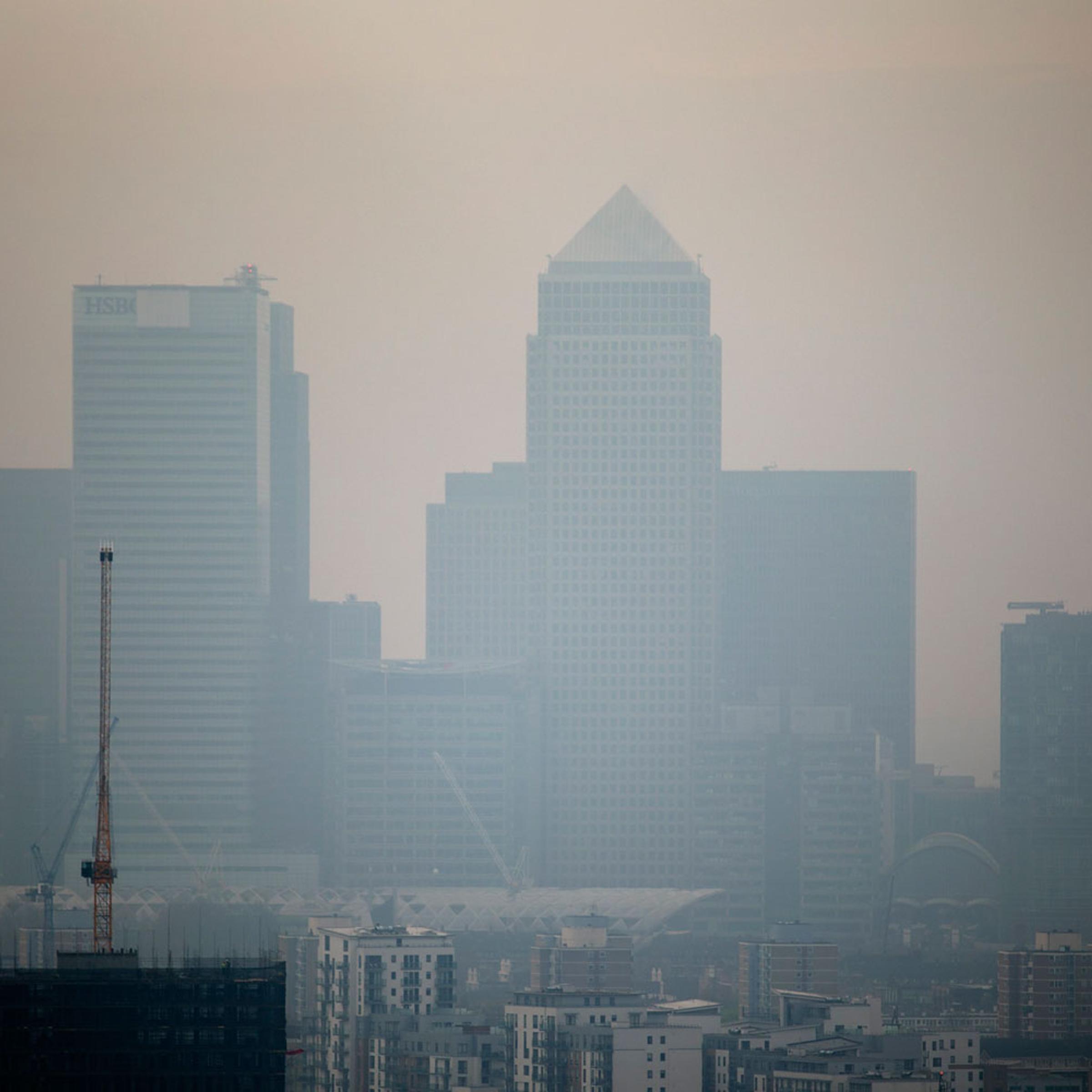 The skyscrapers of the Canary Wharf business district in London are shrouded in smog, April 2, 2014.