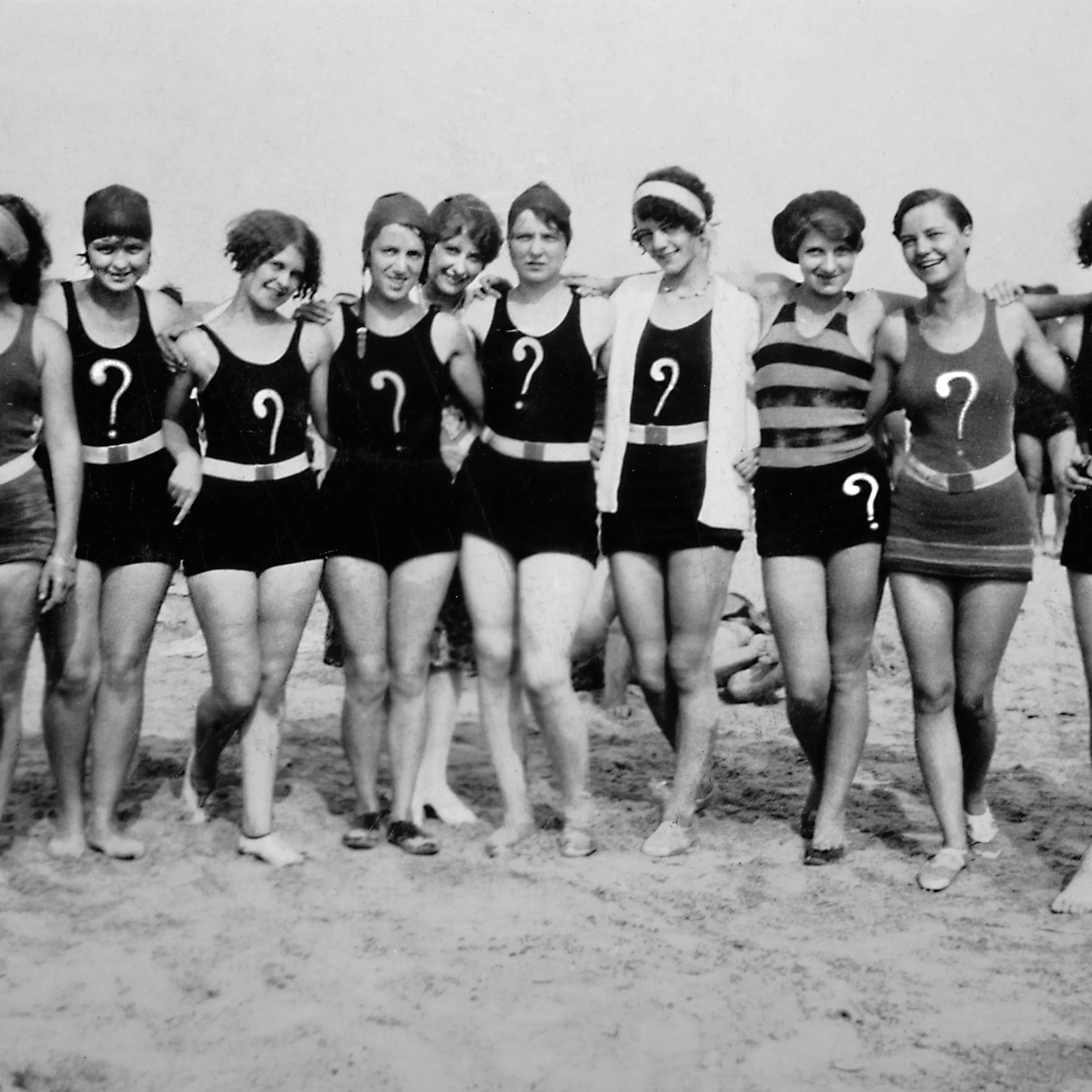 Questioning young women pose on the beach, ca. 1925
