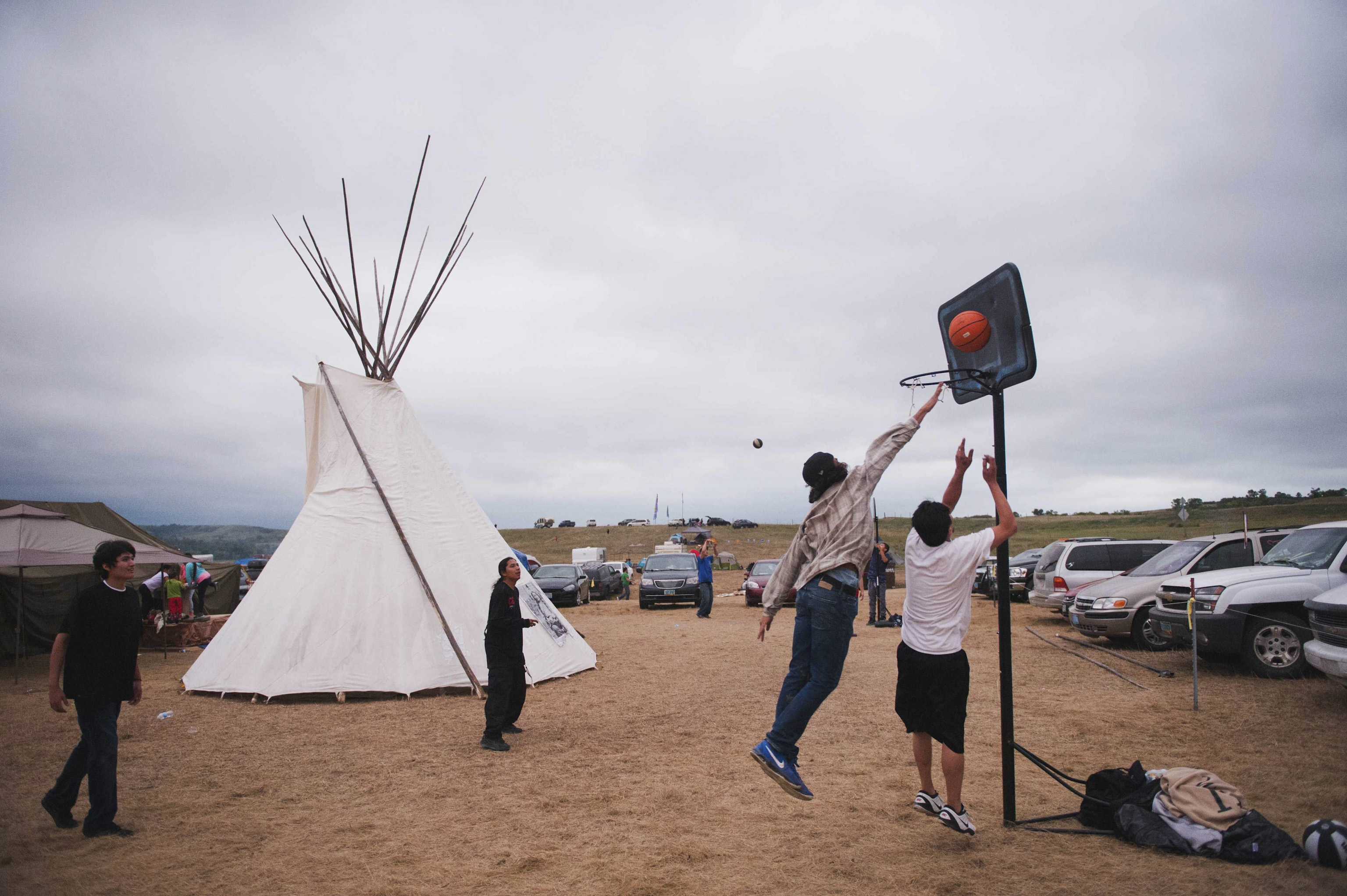 Native American protesters play basketball in an encampment that has grown on the banks of the Cannon Ball River in Cannon Ball, North Dakota, on Sept. 5, 2016.