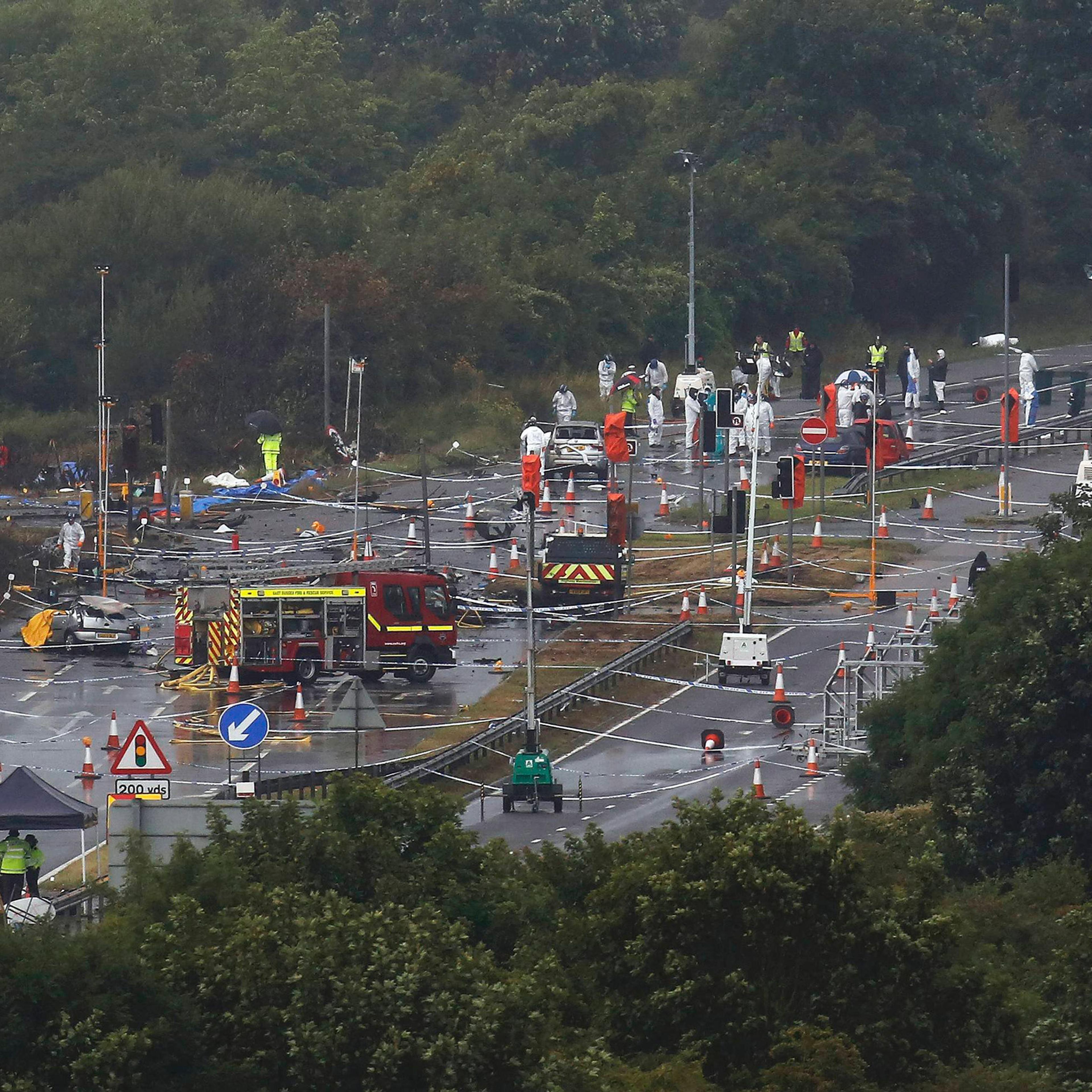 Emergency services and crash investigation officers continue to work at the site where a Hawker Hunter fighter jet crashed onto the A27 road at Shoreham near Brighton