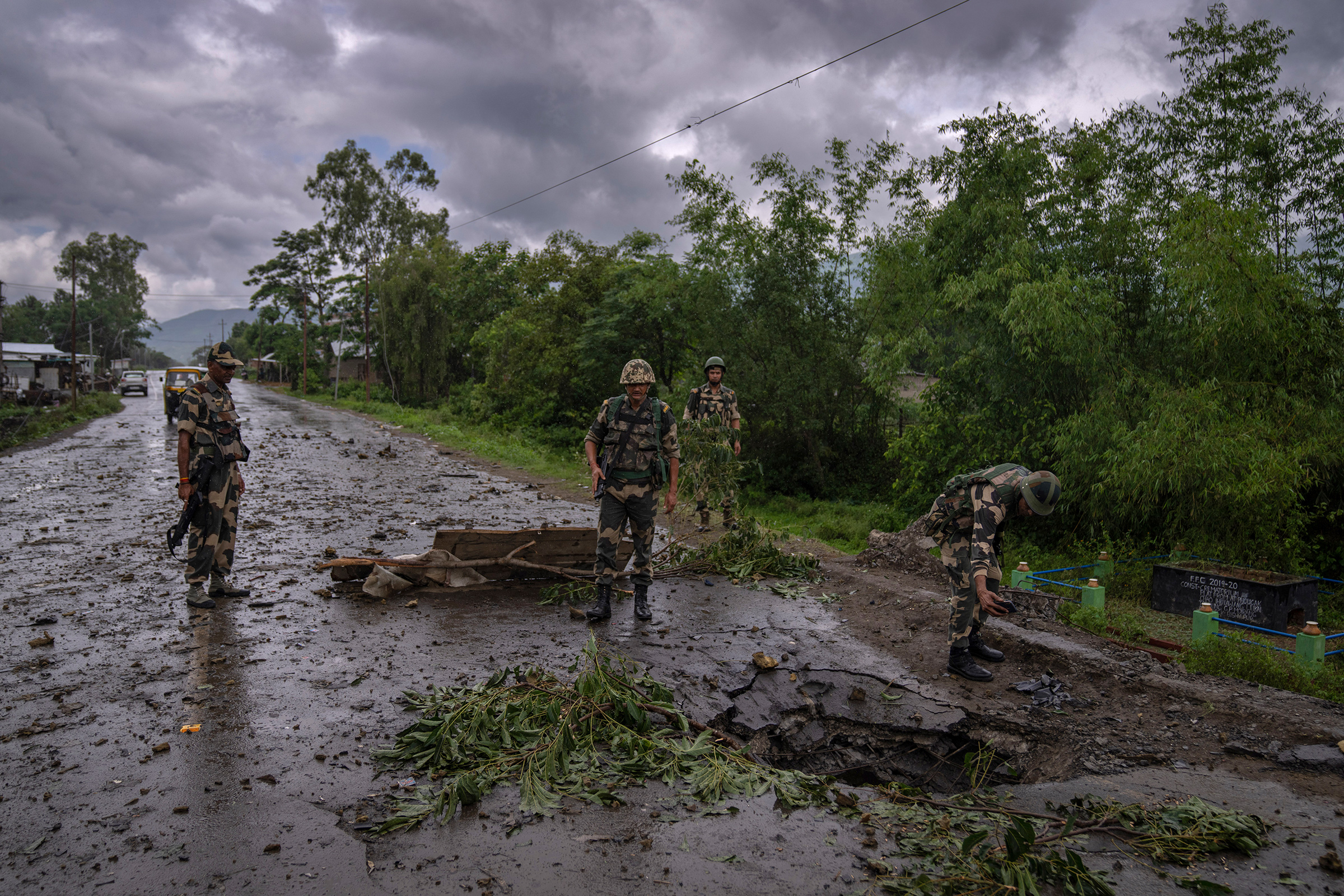 Indian paramilitary soldiers inspect the site of a car bomb explosion in Kwakta, some 50 kilometers from Imphal, capital of the northeastern Indian state of Manipur on June 22. Manipur is caught in a deadly conflict between two ethnic communities that have armed themselves and launched brutal attacks against one another. The clashes, which have left at least 120 dead by the authorities' conservative estimates, persist despite the army’s presence. 