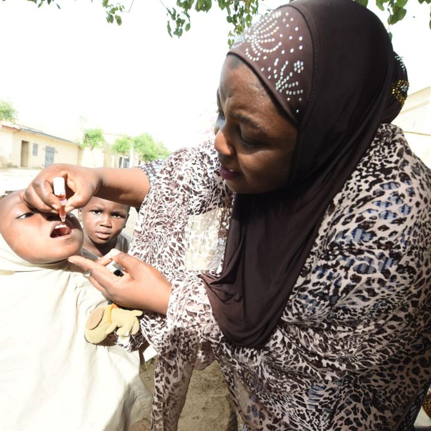 UNICEF health consultant Hadiza Waya immunizes a child during vaccination campaign against polio at Hotoro-Kudu, Nassarawa district of Kano in northwest Nigeria, on April 22, 2017.