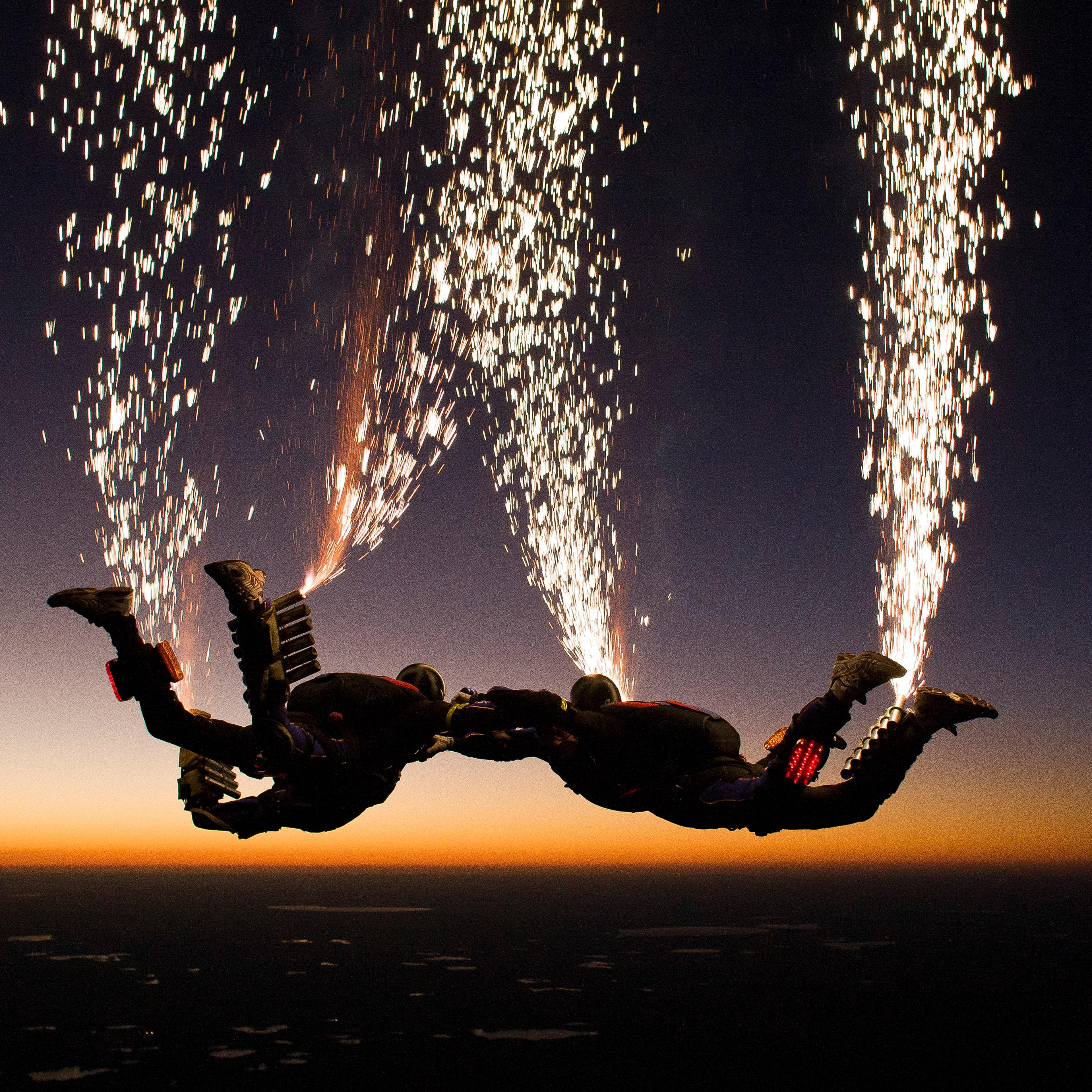 The Fastrax skydiving team set off fireworks as they jump out of the plane.