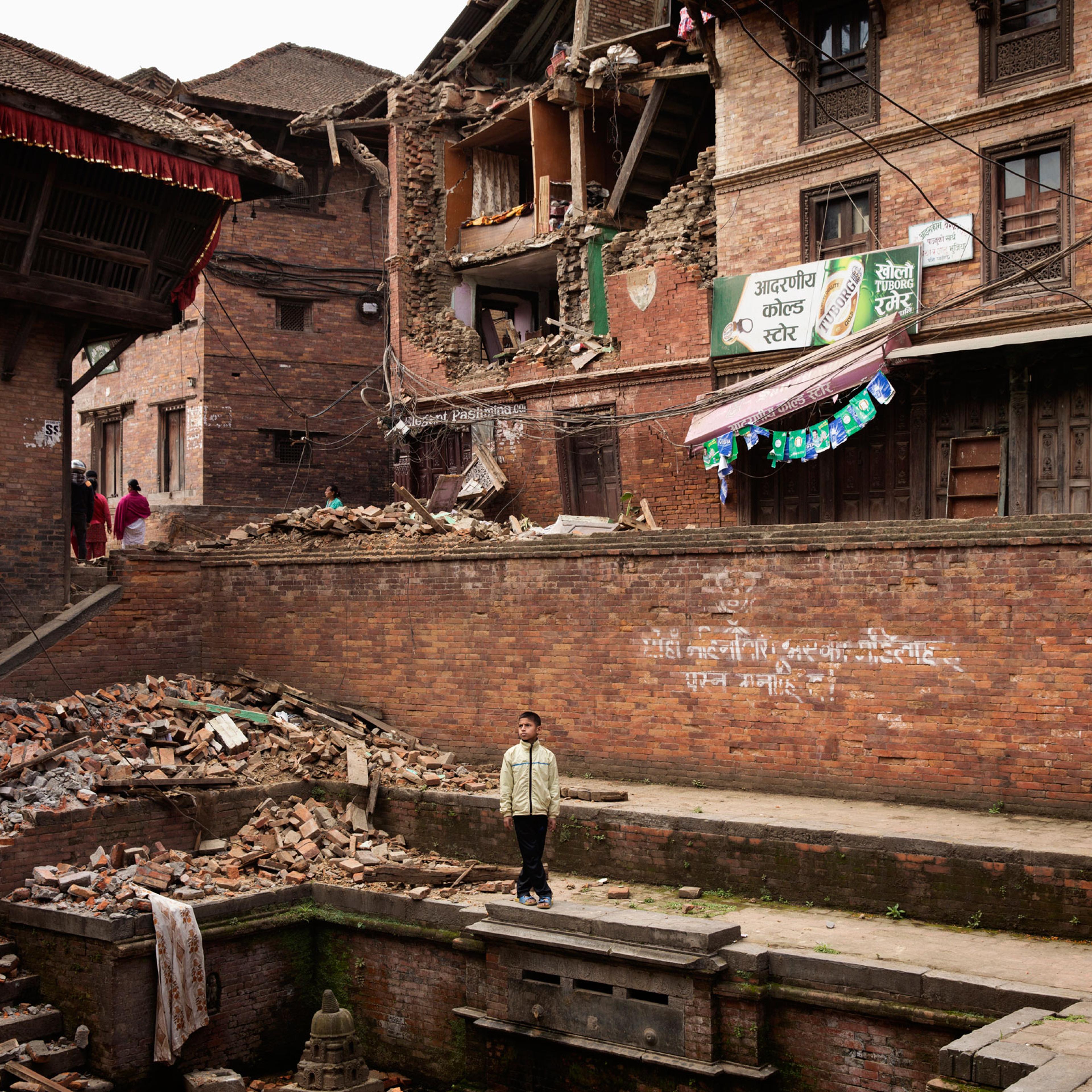 A Nepali boy stands amidst earthquake damage in the ancient city of Bhaktapur in the Kathmandu Valley on April. 28, 2015. Nepal had a severe earthquake on April 25th. Photo by Adam Ferguson for Time