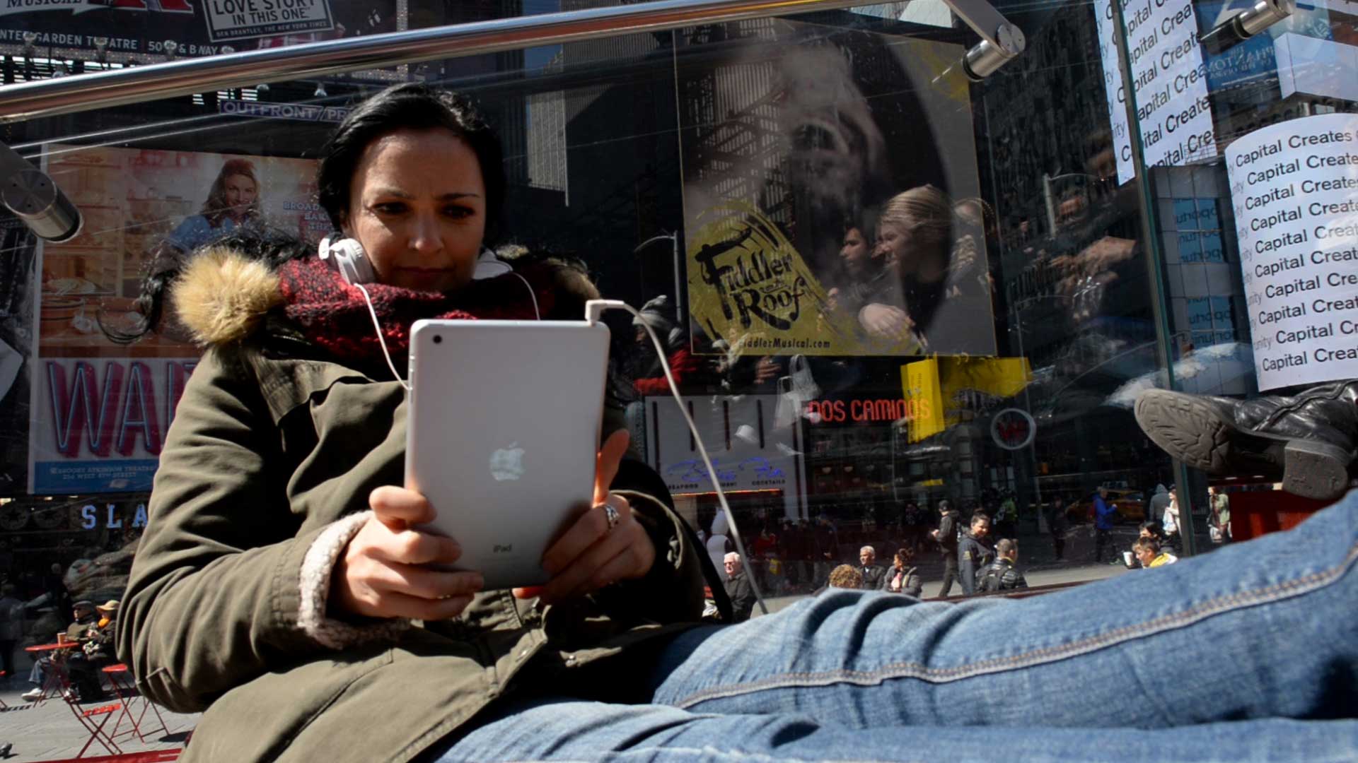 A woman holds an iPad in Times Square, N.Y.