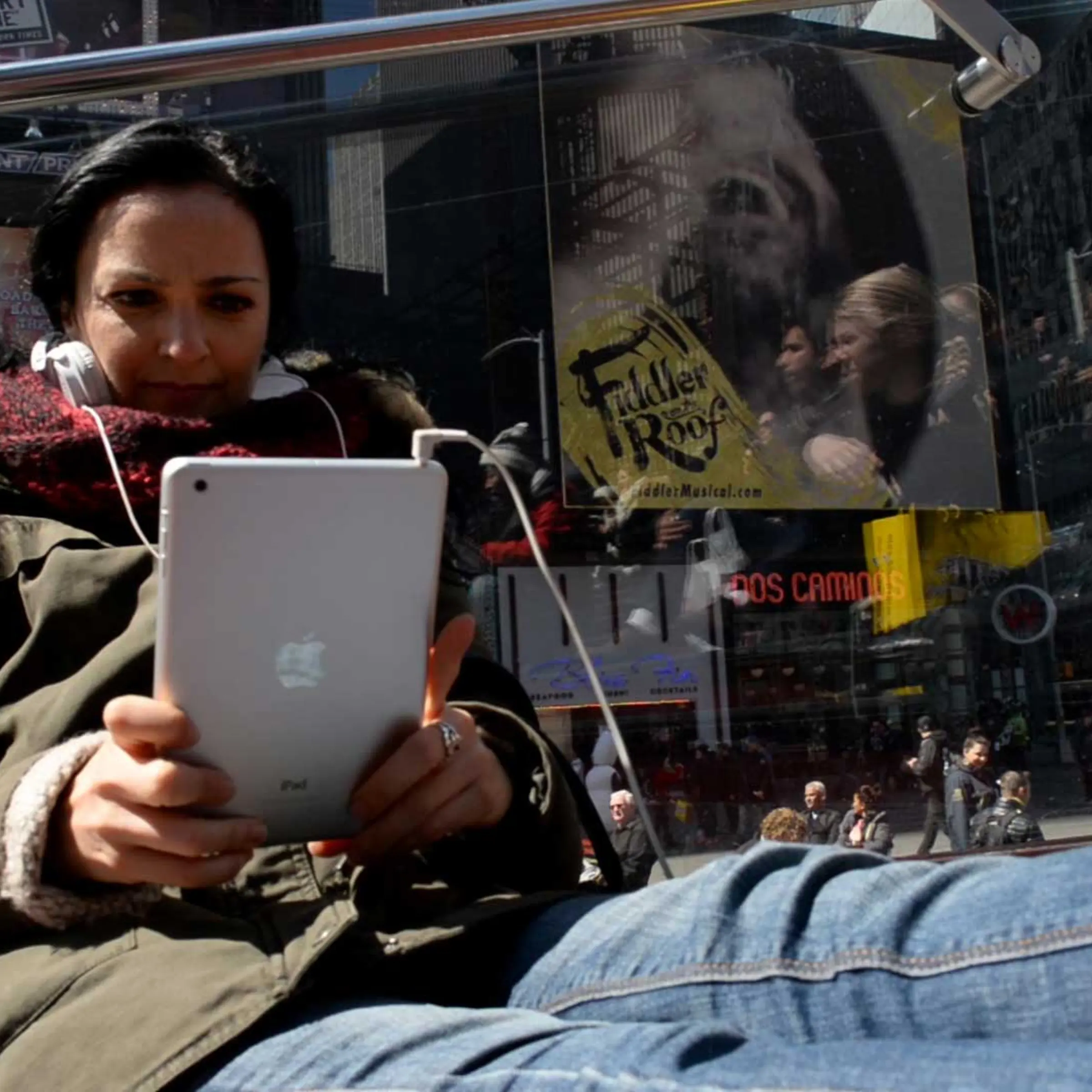 A woman holds an iPad in Times Square, N.Y.