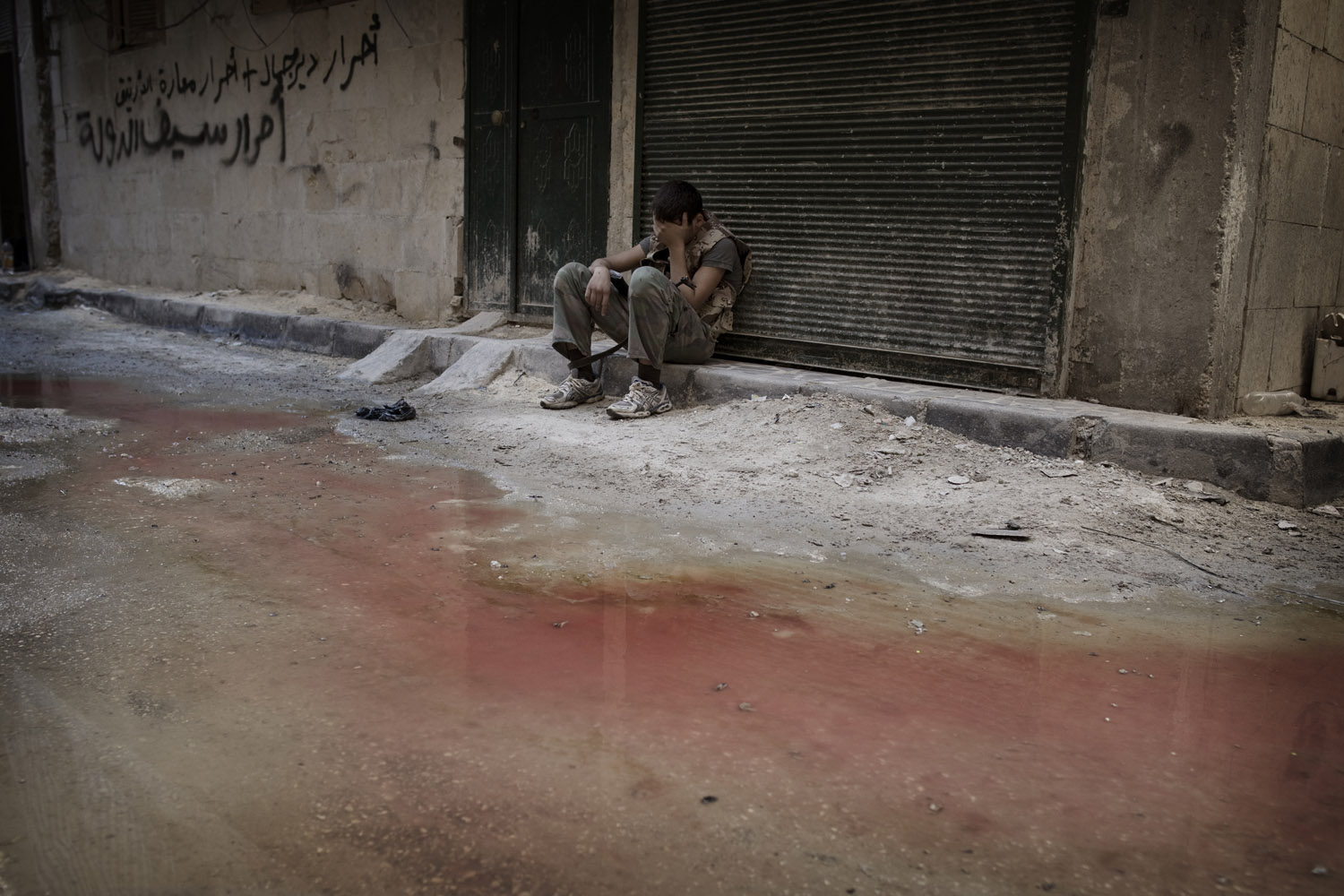 Sept. 2, 2012. A Free Syrian Army fighter rests in exhaustion after heavy fighting in Aleppo, Syria. 
