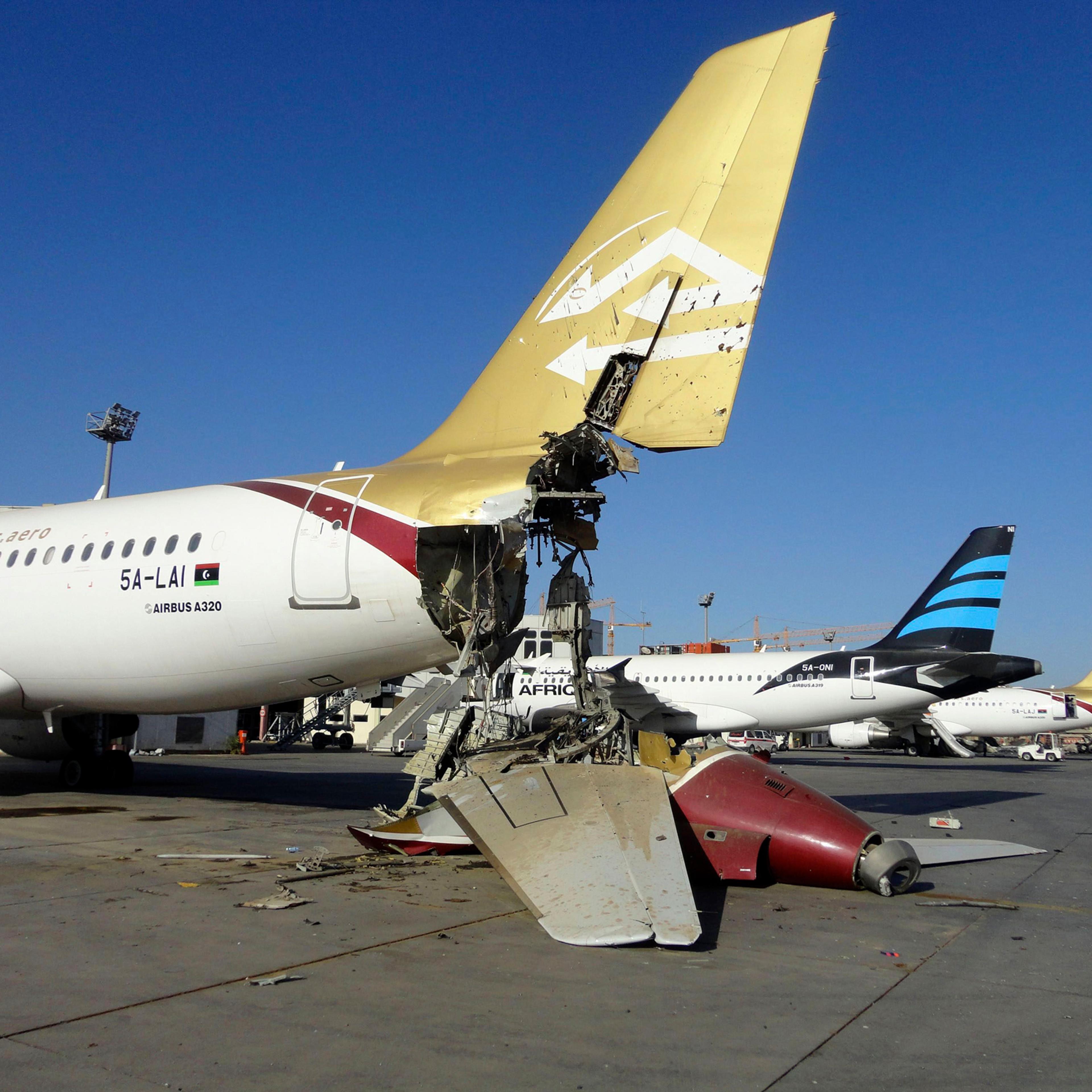 A damaged aircraft is pictured after shelling at Tripoli International Airport, Aug. 24, 2014.