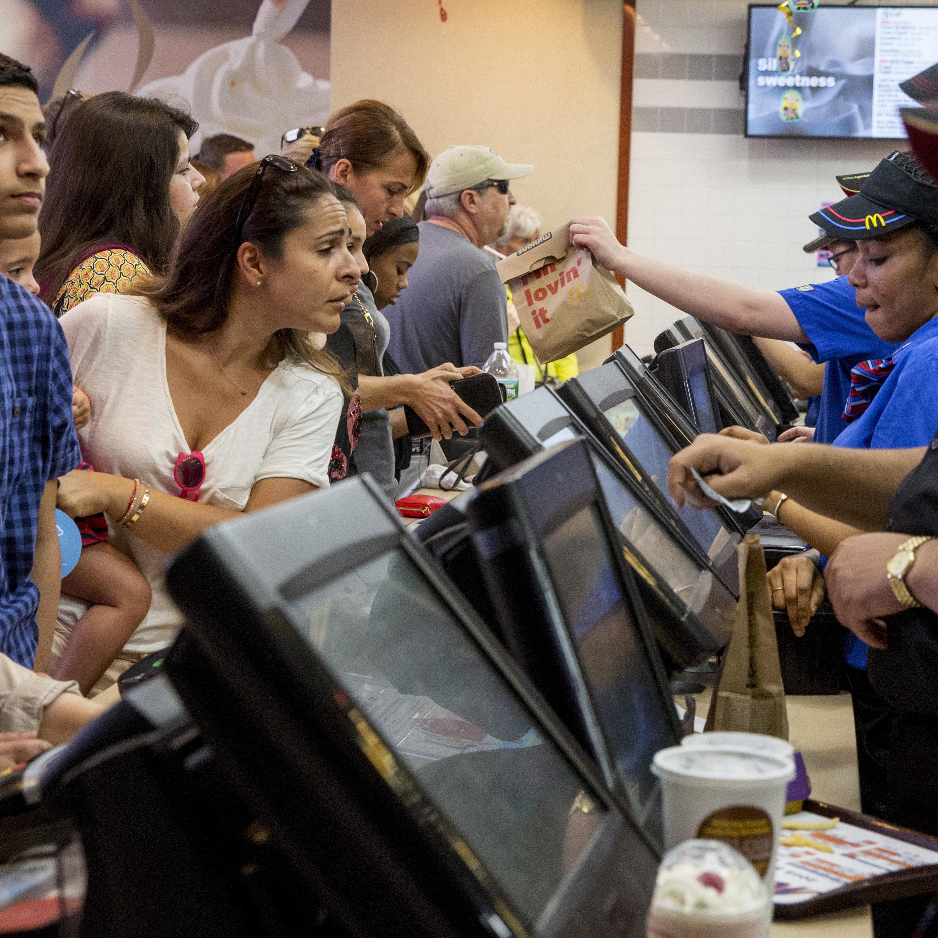 Customers are served at a McDonald's in Times Square in New York on July 23, 2015.
