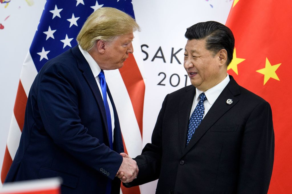 China's President Xi Jinping (R) shakes hands with US President Donald Trump before a bilateral meeting on the sidelines of the G20 Summit in Osaka