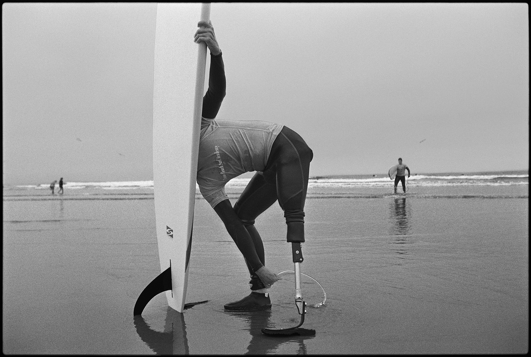 Derek McGinnis, who lost a leg in Iraq, tries surfing for the first time, in Pismo Beach, Calif., October 2006. 